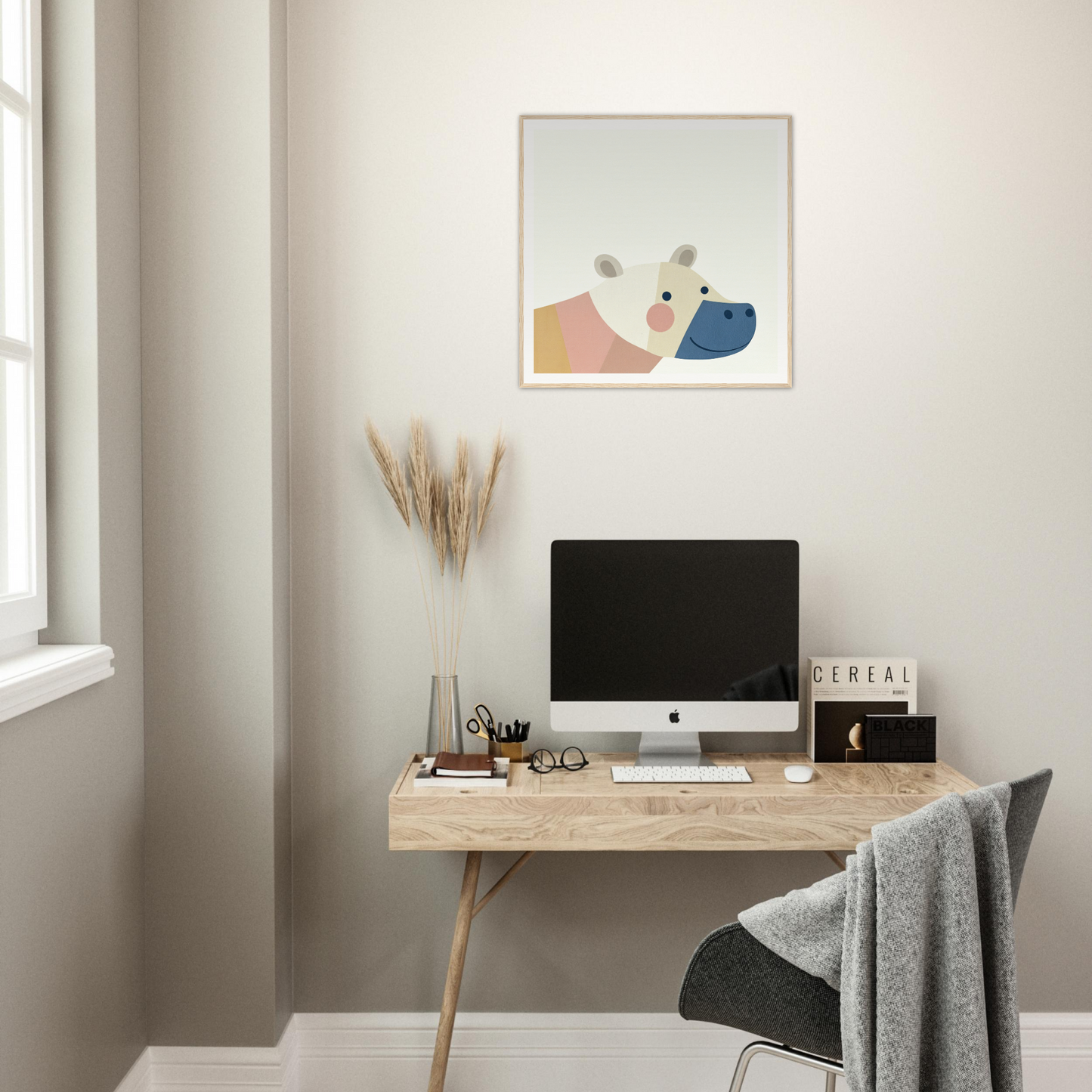 Wooden desk with iMac and minimal accessories, perfect for nursery decor and framed posters