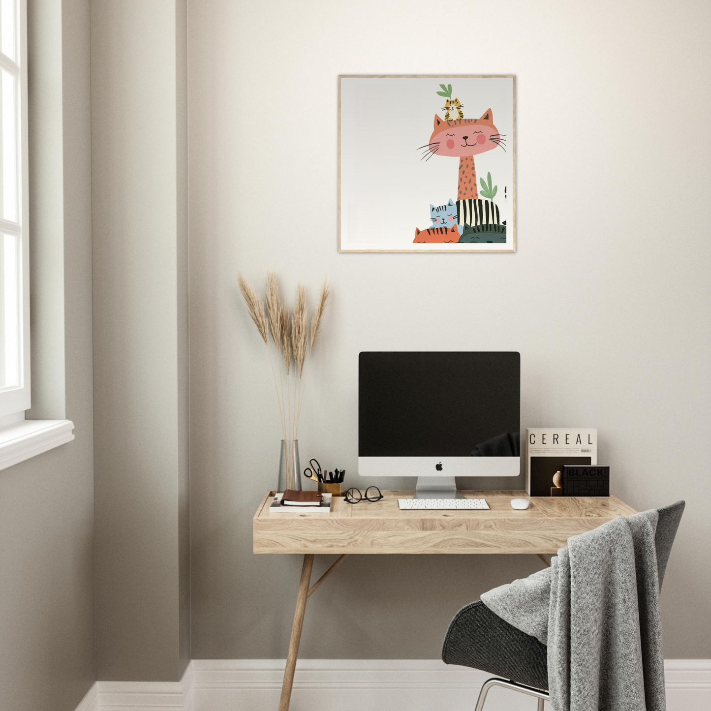 Simple wooden desk with an iMac and nursery wall art above it for stylish decor