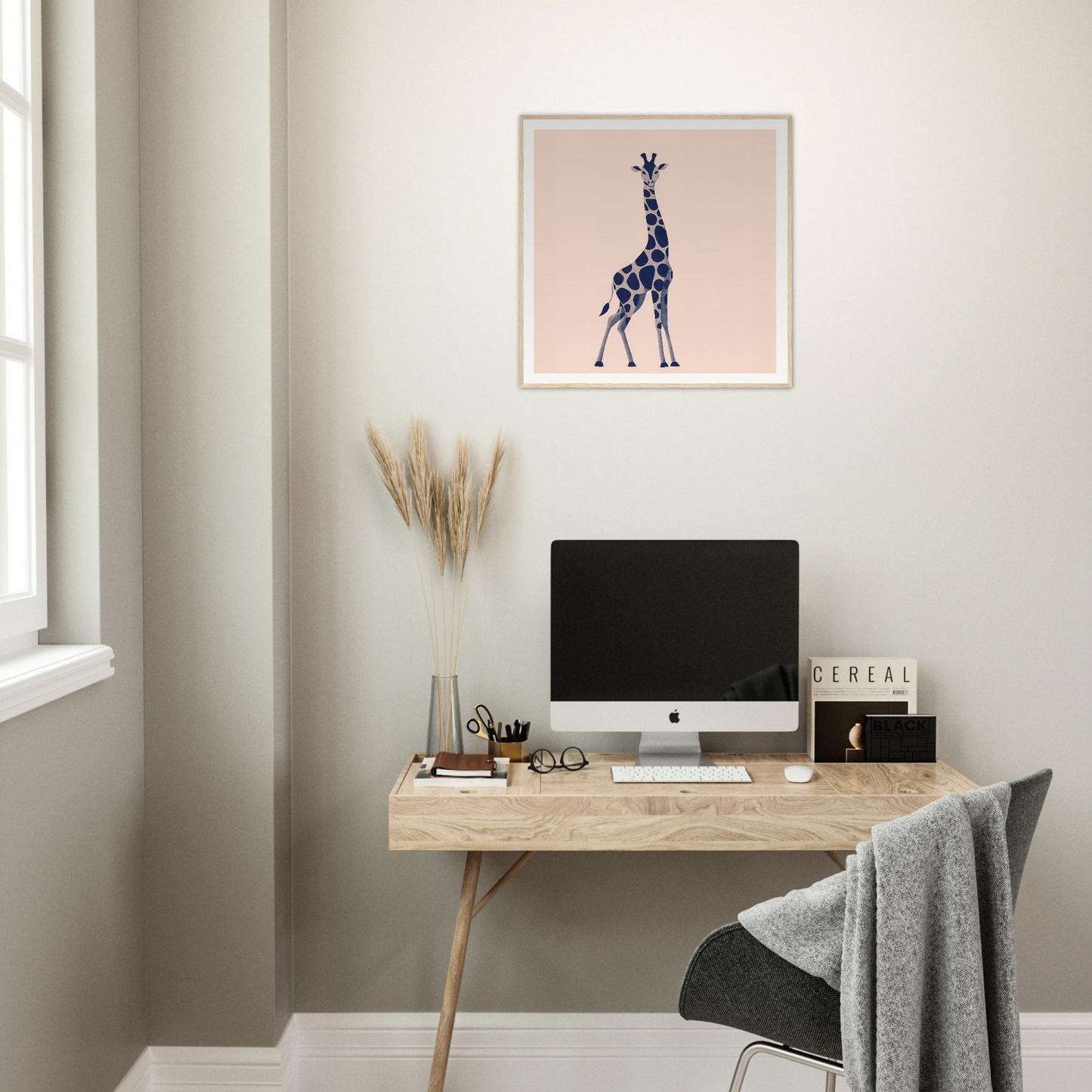 Minimalist home office with iMac, wooden desk, and giraffe nursery wall art decor