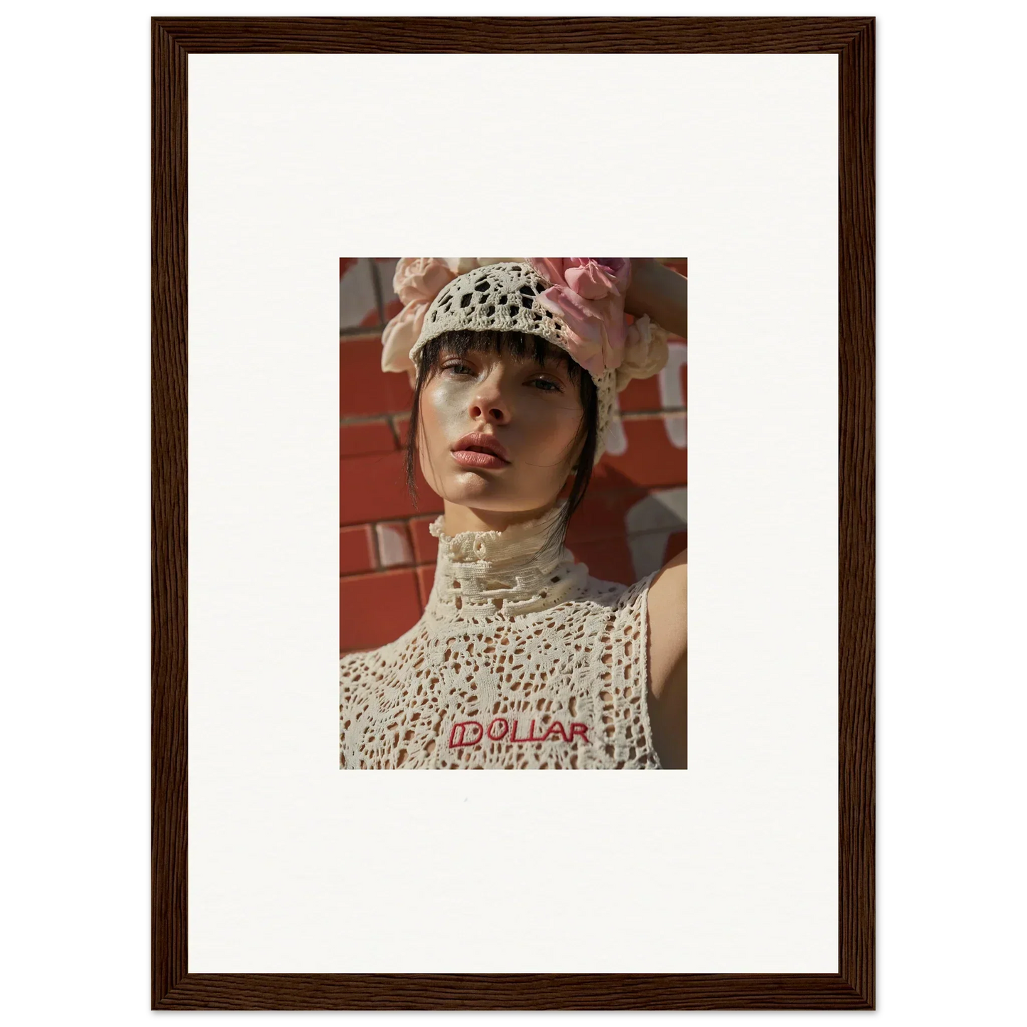 Framed portrait photograph of a person wearing a white crocheted hat and high-necked top.