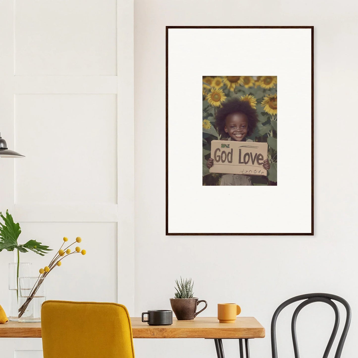 Framed wall art of a child holding a God Love sign for daisetism unfolding room decor