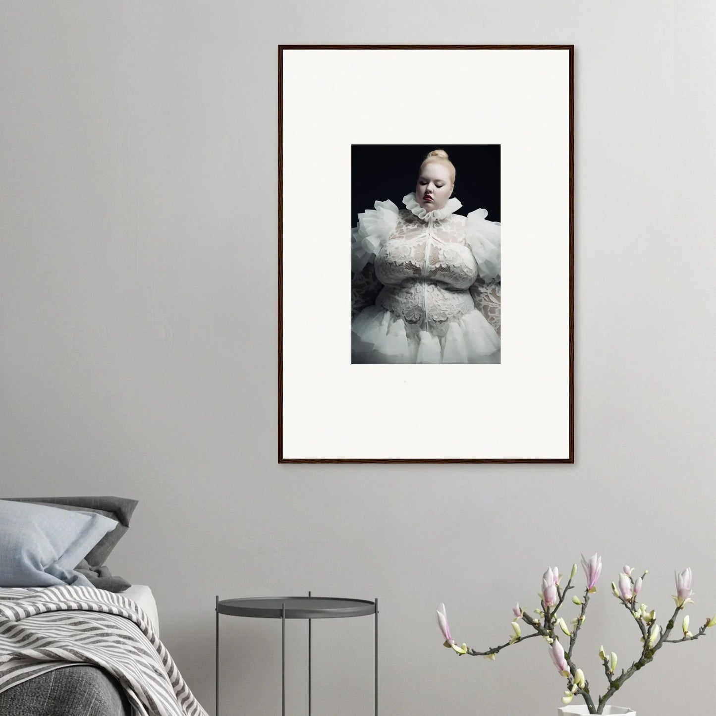 Framed black and white photograph of a figure enveloped in voluminous white fabric.