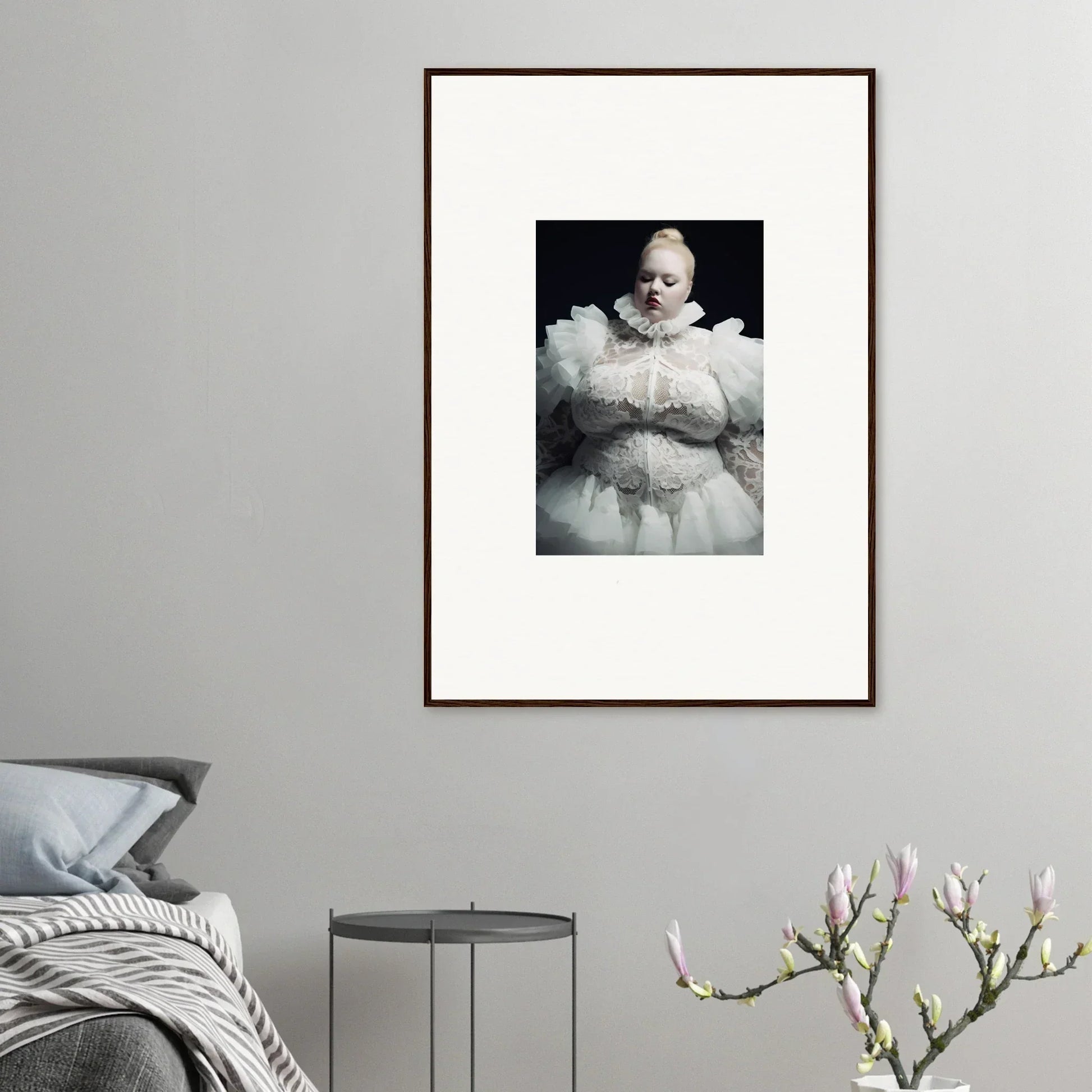 Framed black and white photograph of a figure enveloped in voluminous white fabric.