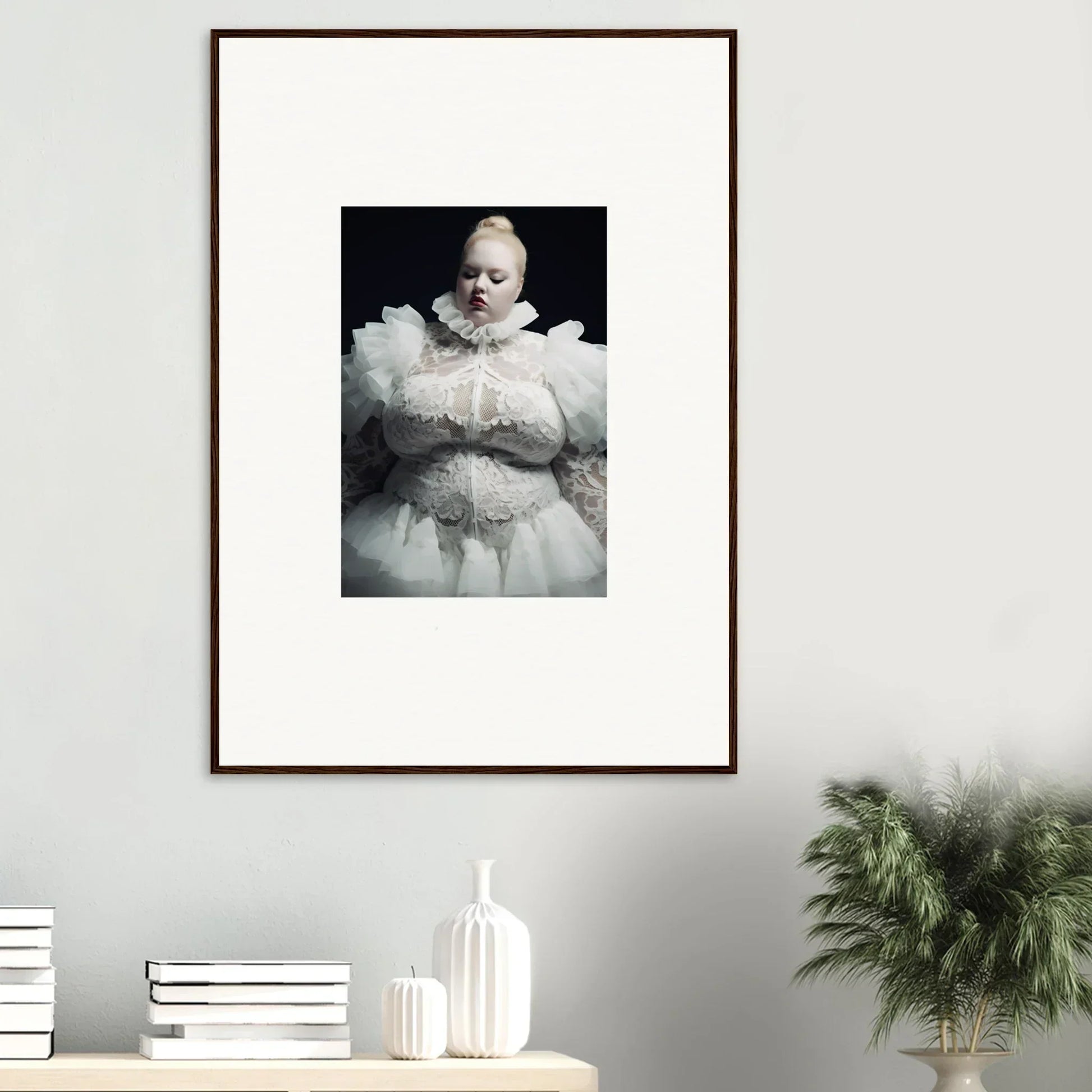 Framed black and white photograph of a baby wearing an ornate white christening gown.