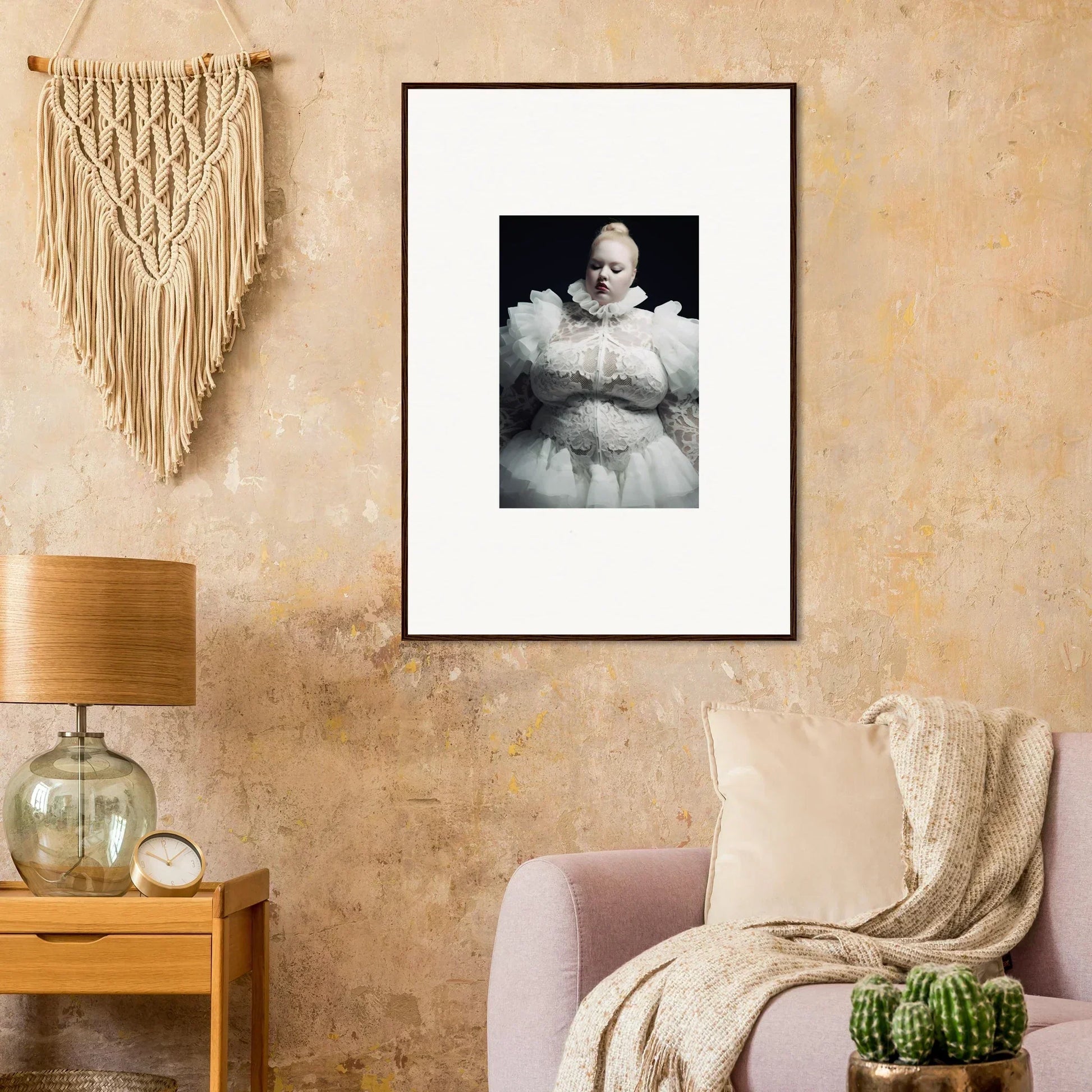 Framed black and white photograph of a baby in fluffy white clothing.