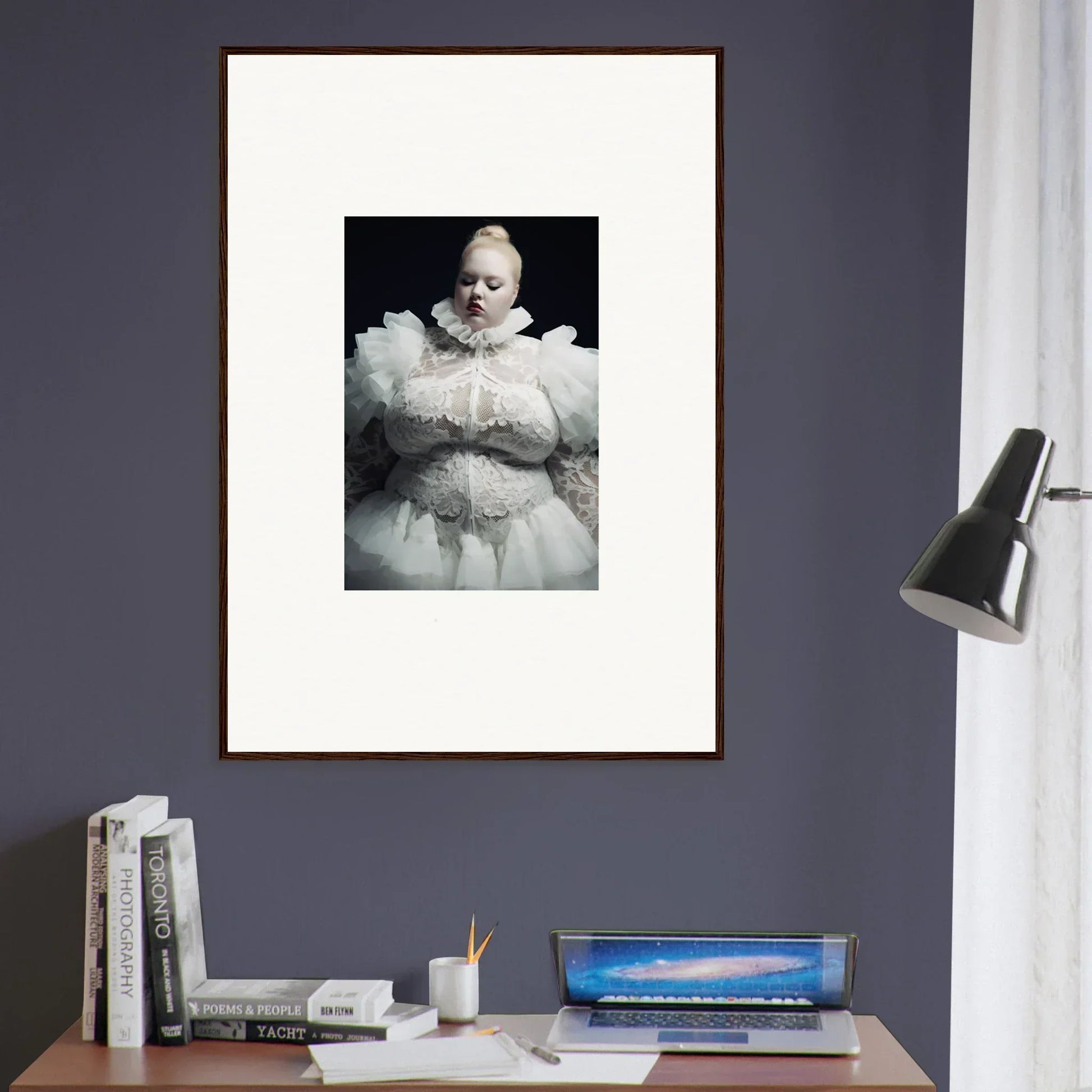 Framed black and white photograph of a baby wearing an ornate white christening gown.