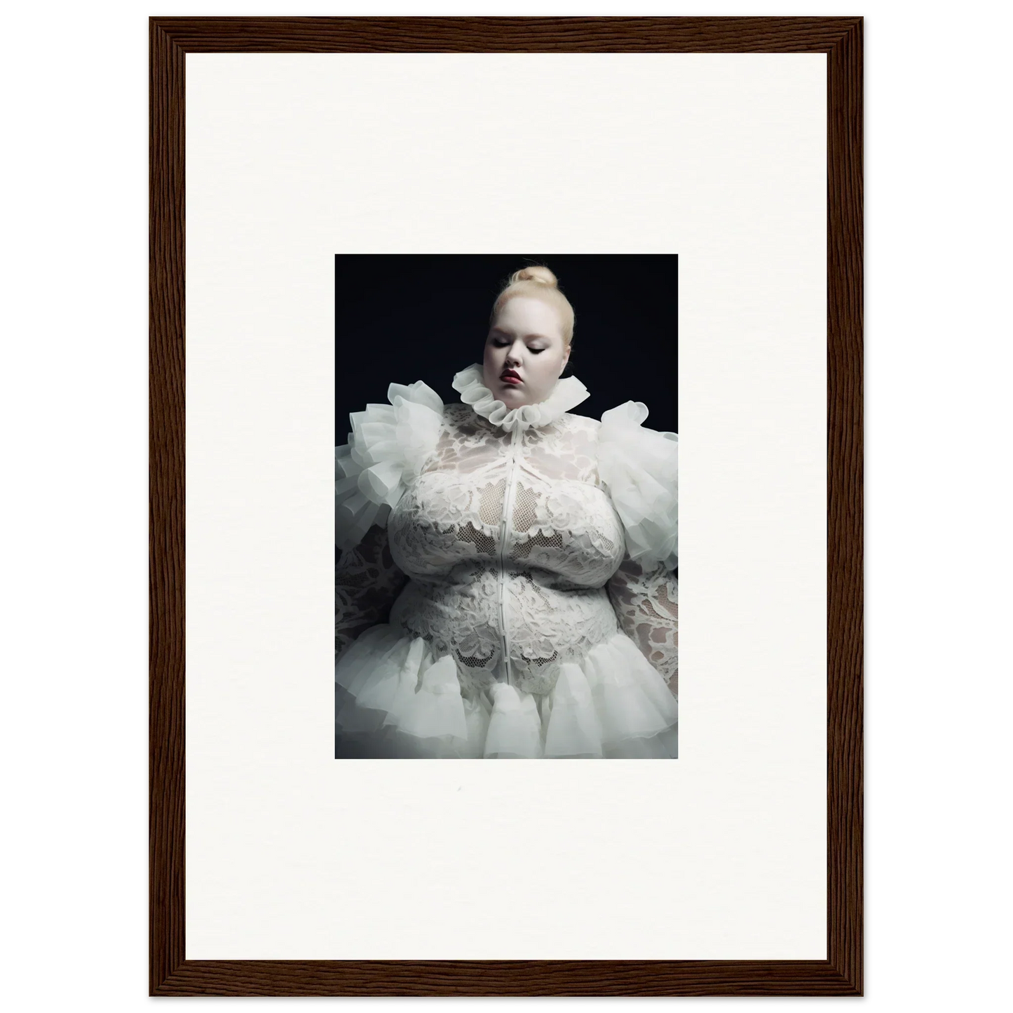 Framed portrait of a pale figure wearing an elaborate white ruffled costume against a dark background.