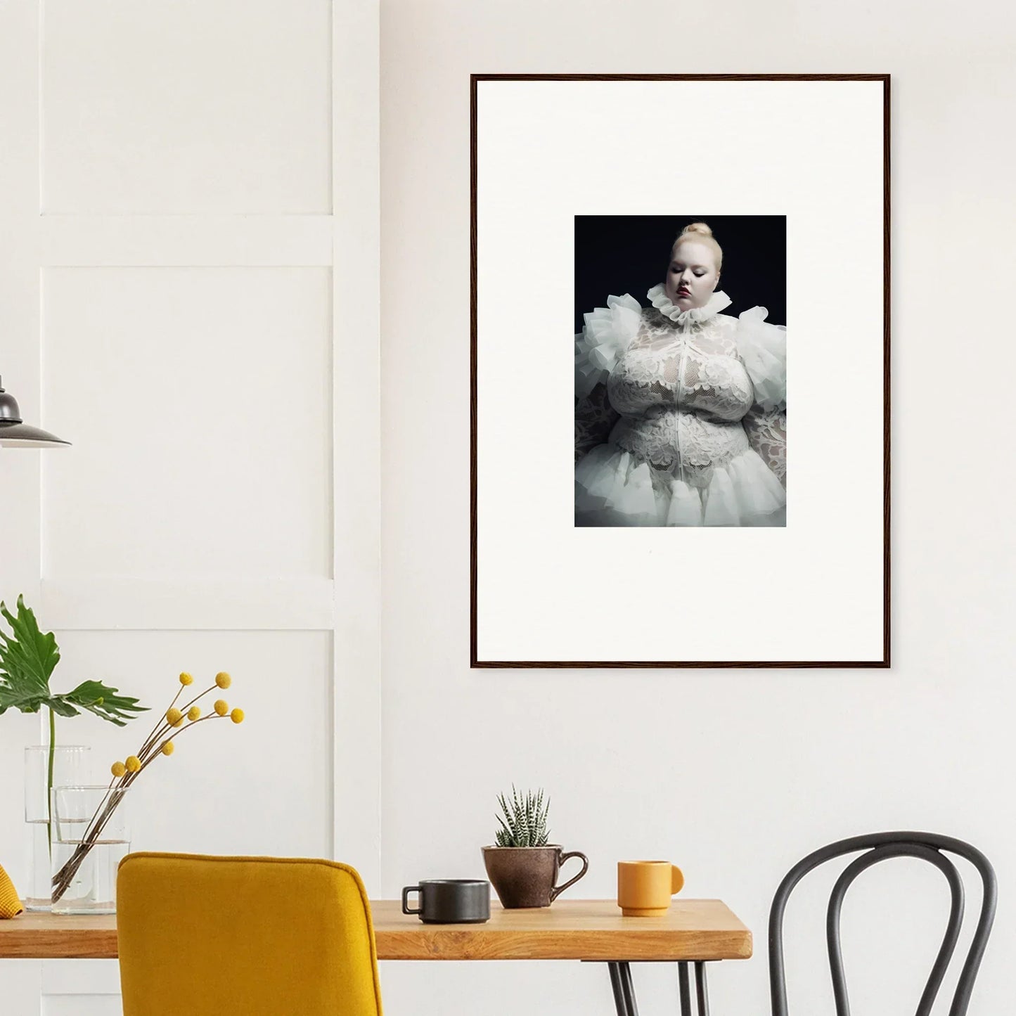 Framed black and white photograph of a figure in a white, puffy outfit.