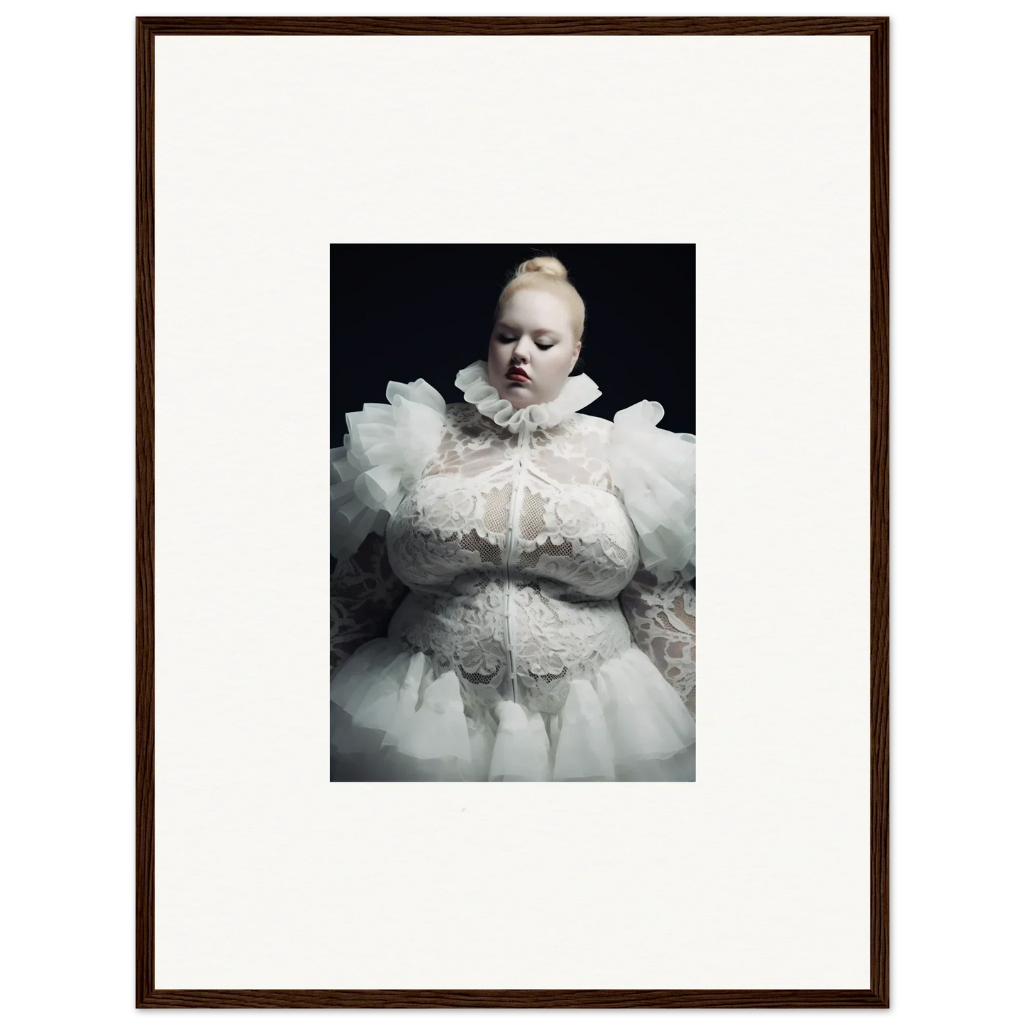 Pale figure in an elaborate white ruffled costume against a dark background.