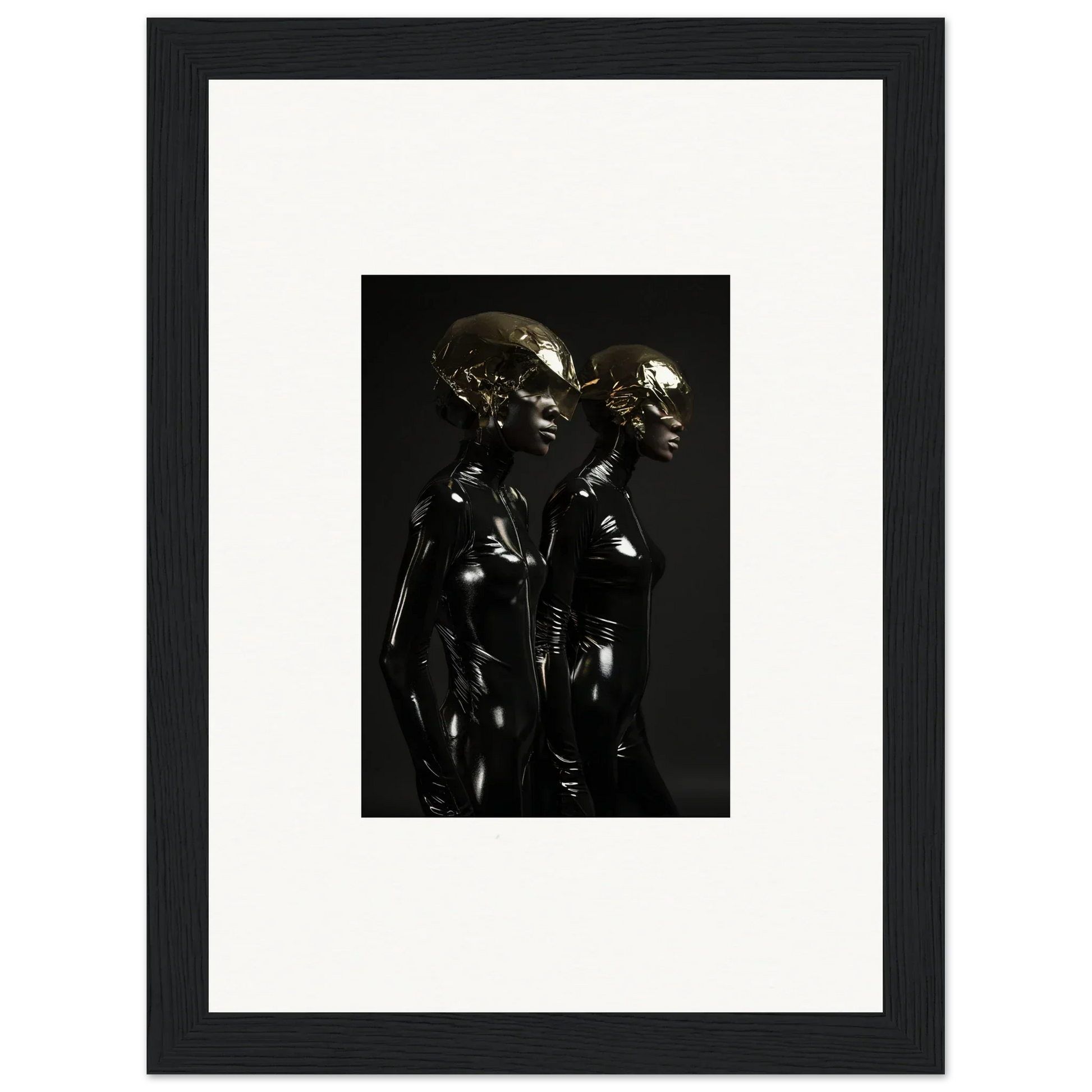 Framed black and white photograph of two metallic humanoid figures standing close together.