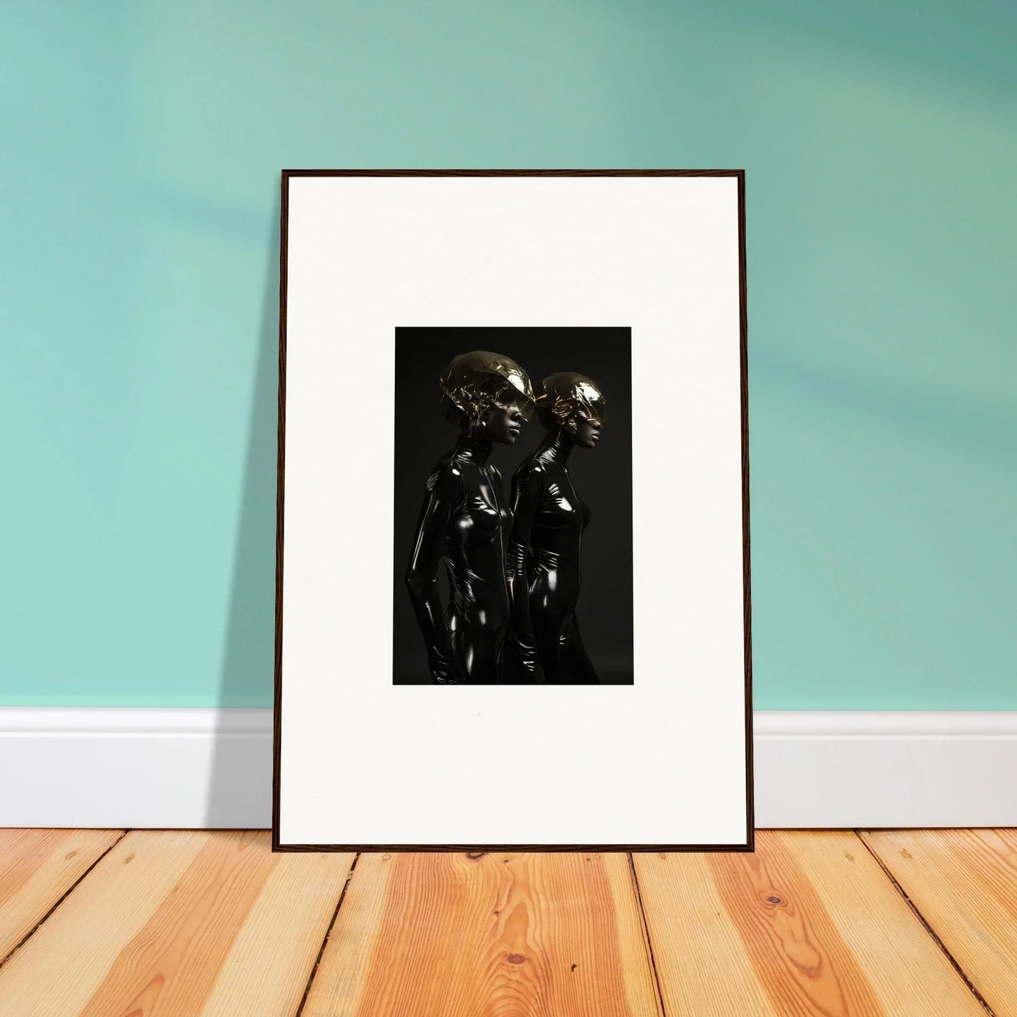 Framed black and white artwork depicting two figures in relief.