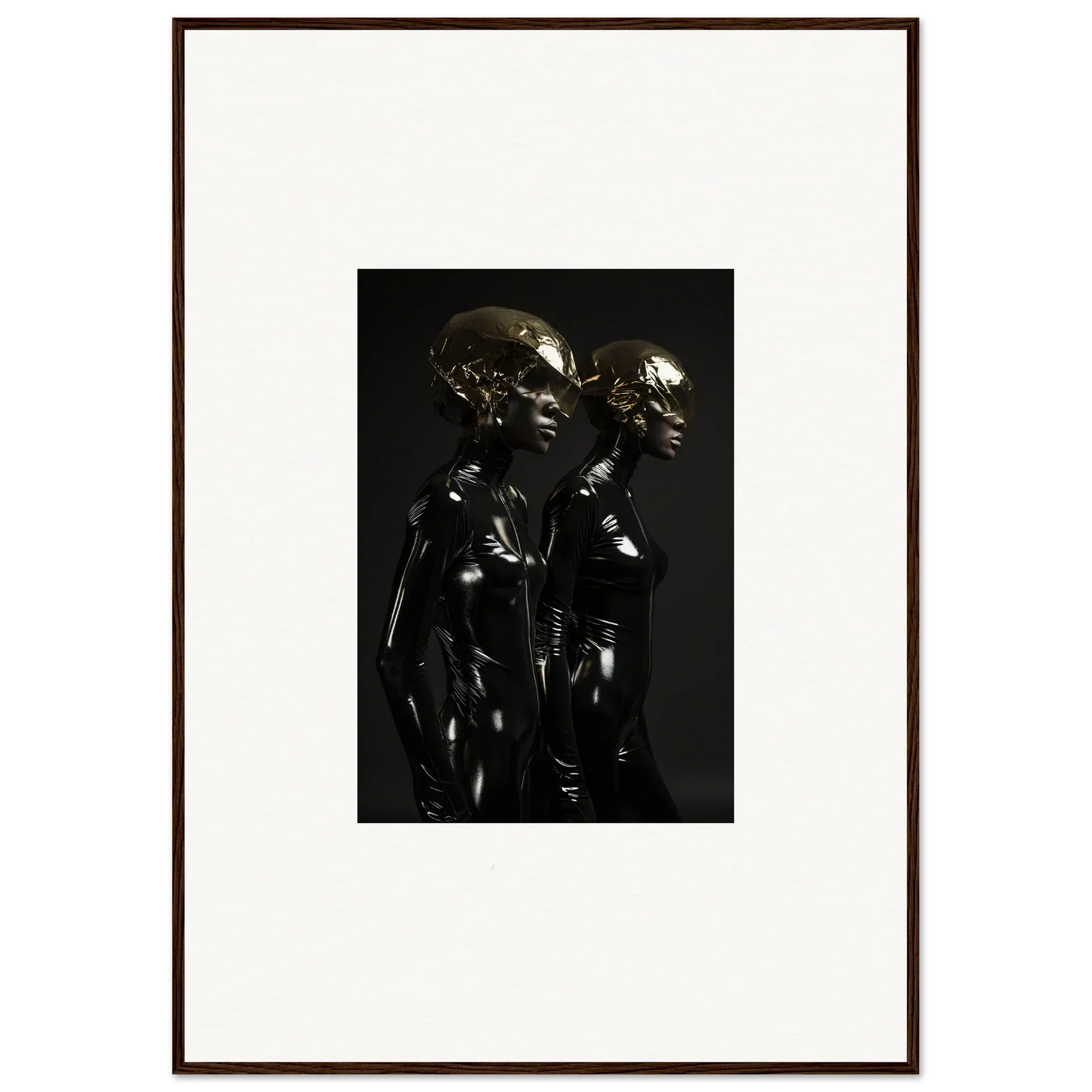Dark metallic sculpture depicting two stylized humanoid figures standing close together.