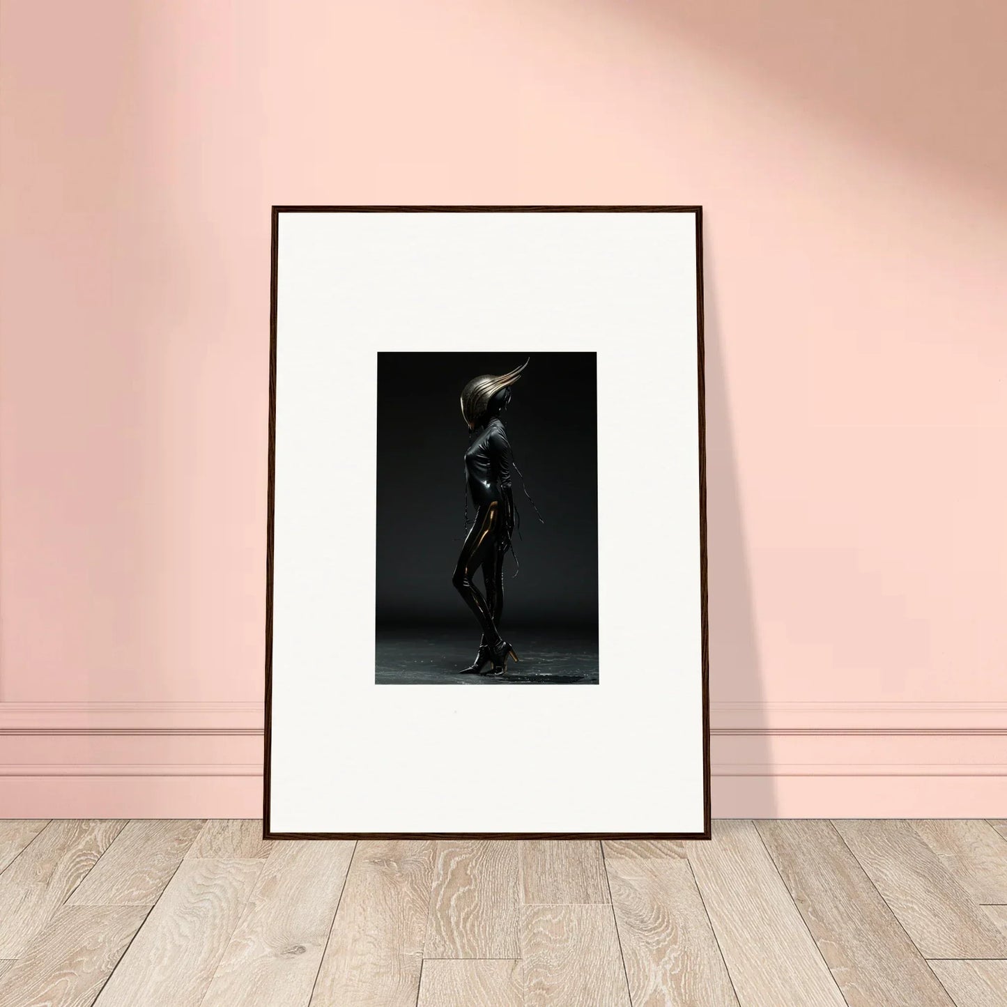 Framed black-and-white photograph of a silhouetted figure holding a glowing orb or light source.