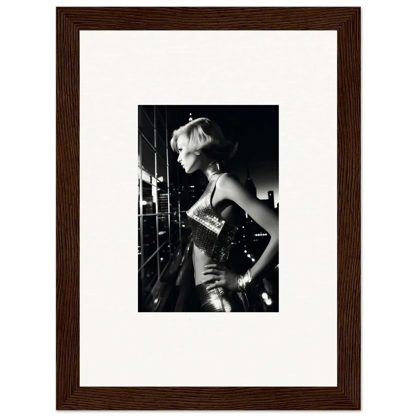 Framed black and white photograph of a woman in a glamorous outfit.