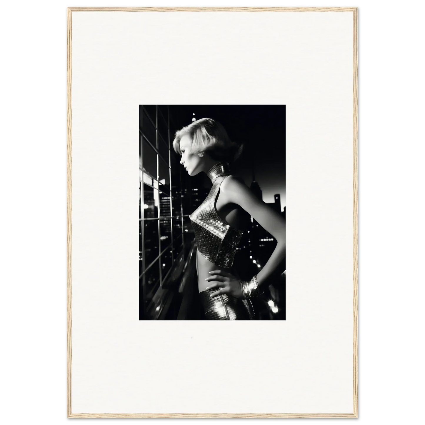 Black and white photograph of a woman in a glamorous sequined outfit with short blonde hair.