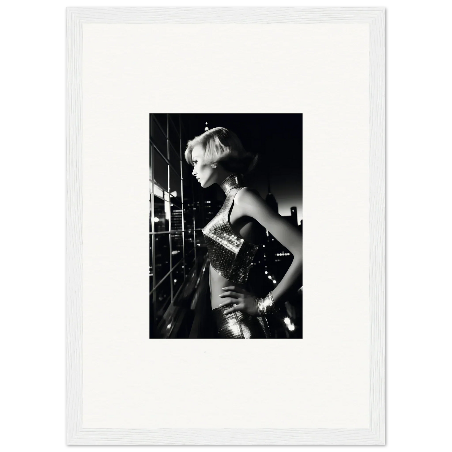 Black and white photograph of a woman in a shimmering, form-fitting dress, captured in profile.