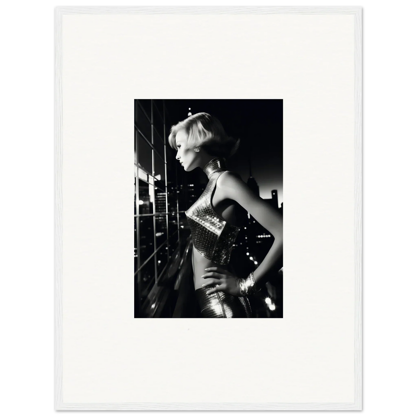Black and white photograph of a woman in a shimmering dress with short blonde hair.