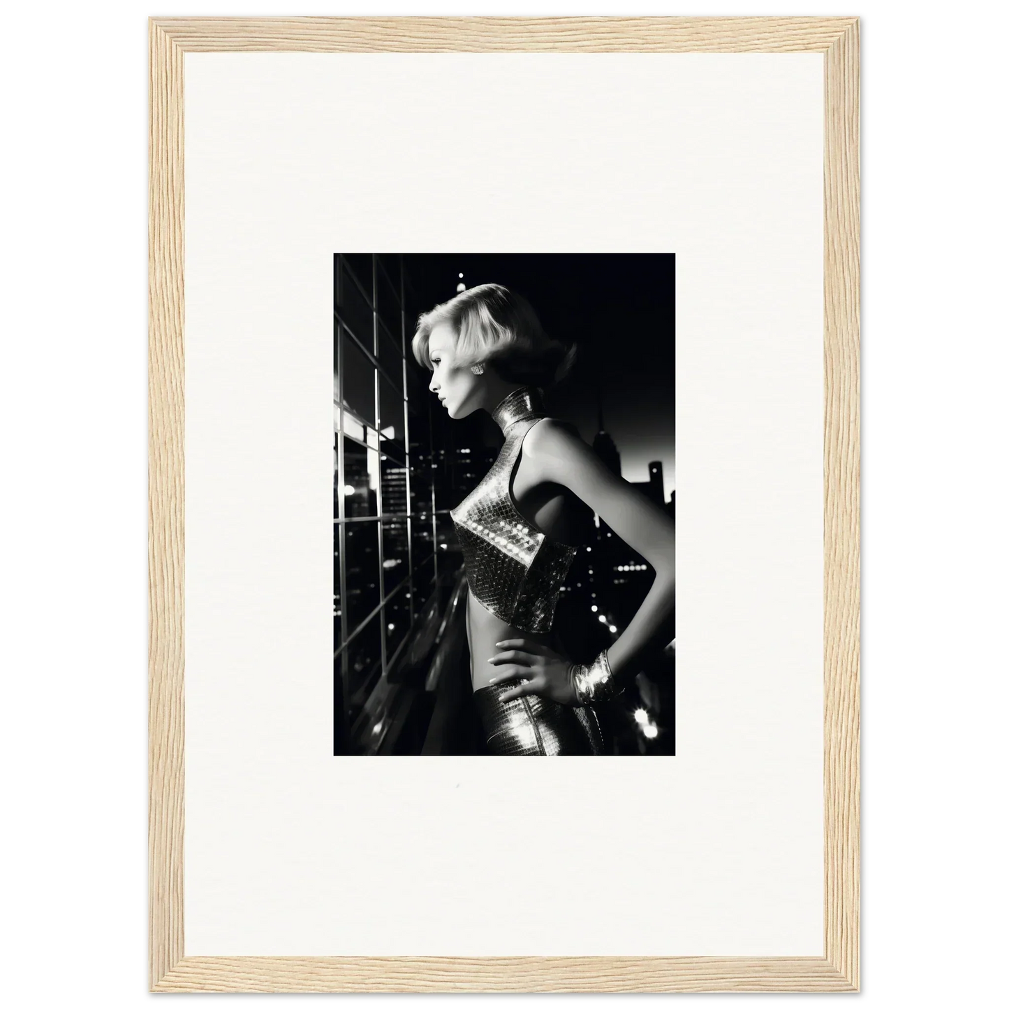 Black and white photograph of a woman in a sparkly dress, framed in a light wooden frame.