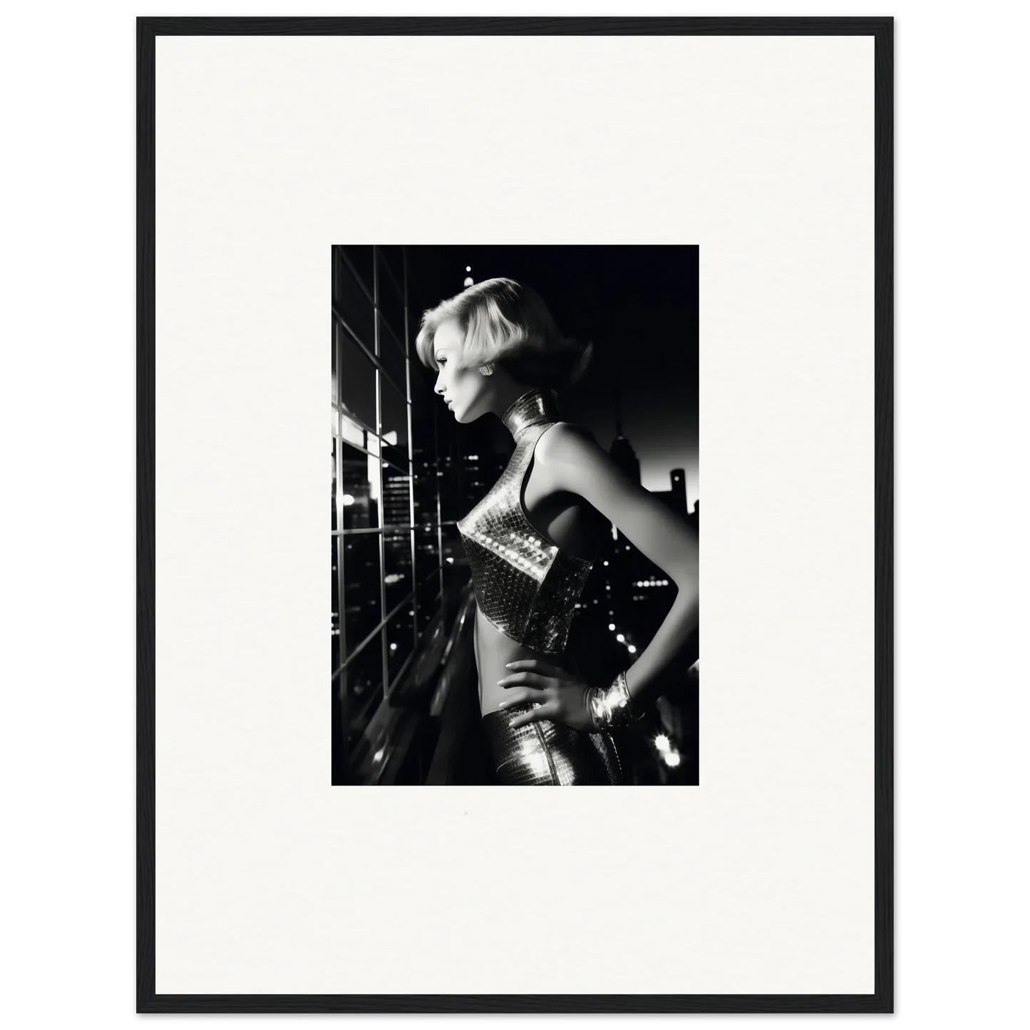 Black and white photograph of a woman in a shimmering dress posing dramatically.