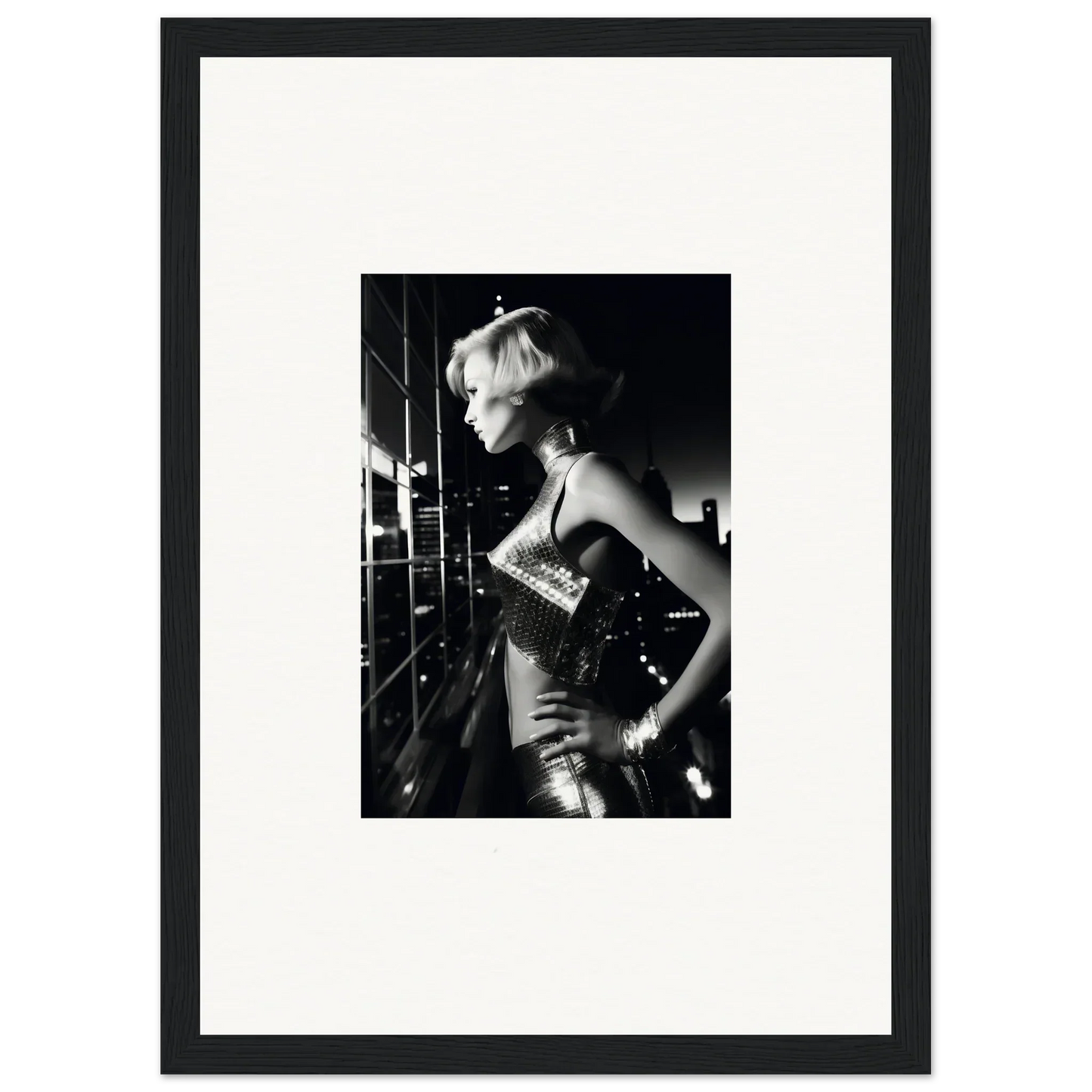 Black and white photograph of a person in a shimmering outfit, striking a dramatic pose.