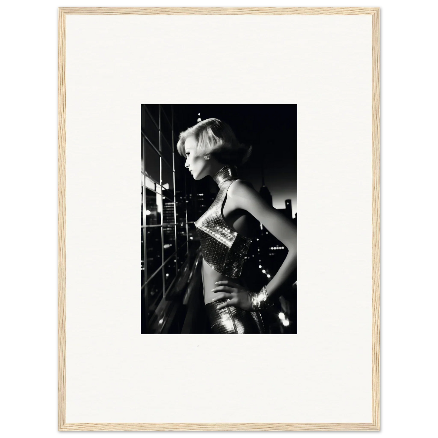 Black and white photograph of a woman in a shimmering dress looking to the side.