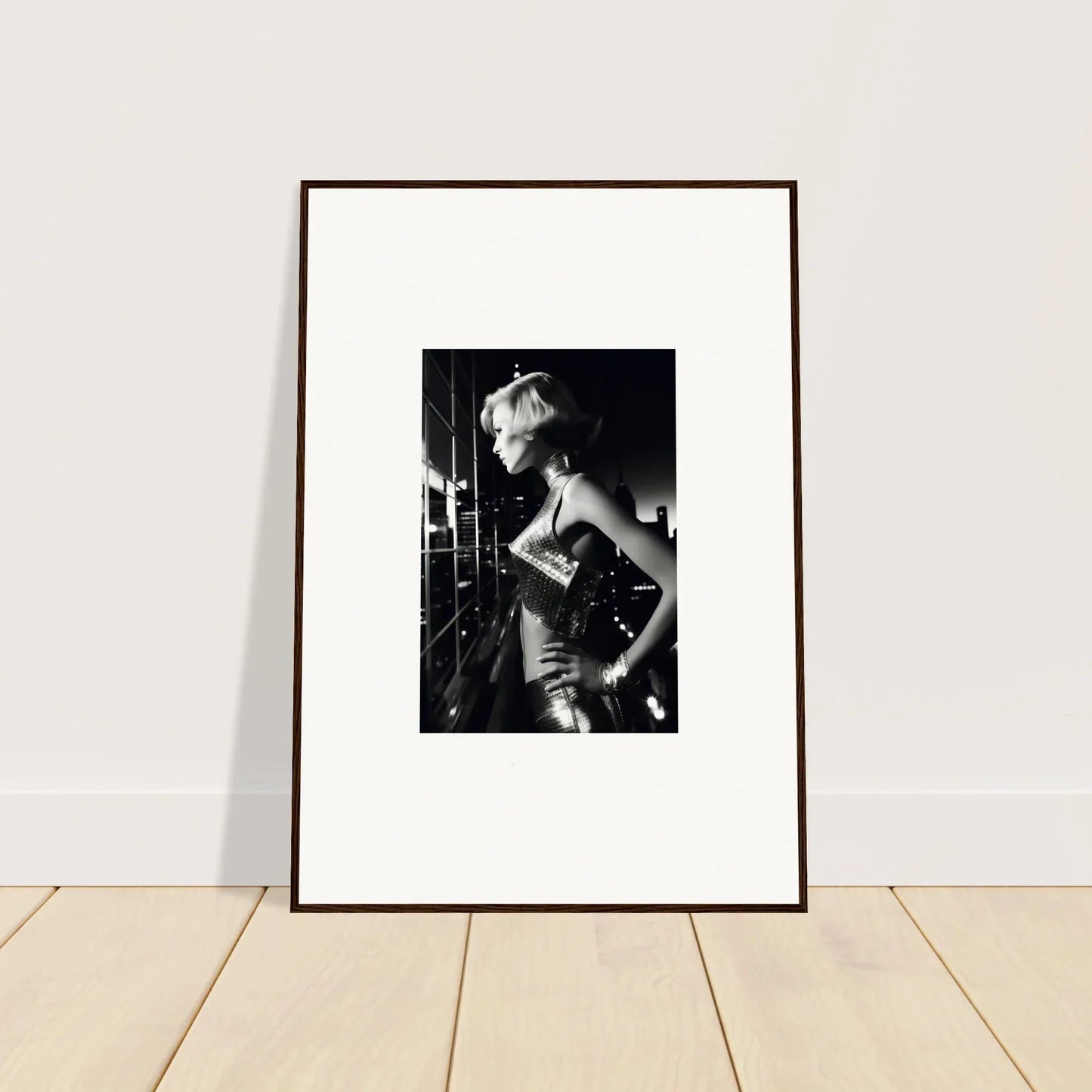 Framed black and white photograph of a woman in a glamorous pose.