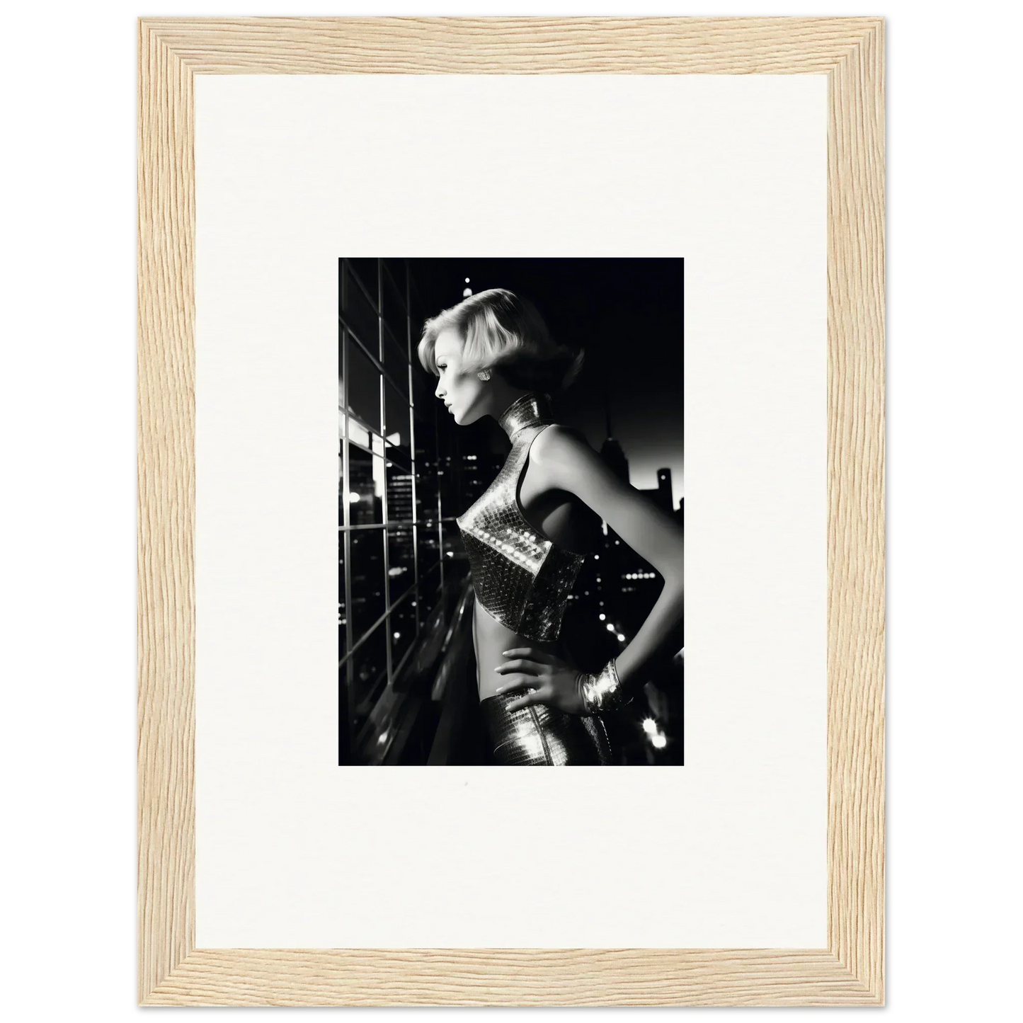 Black and white photograph of a woman in a sparkly dress, framed in a light wooden frame.