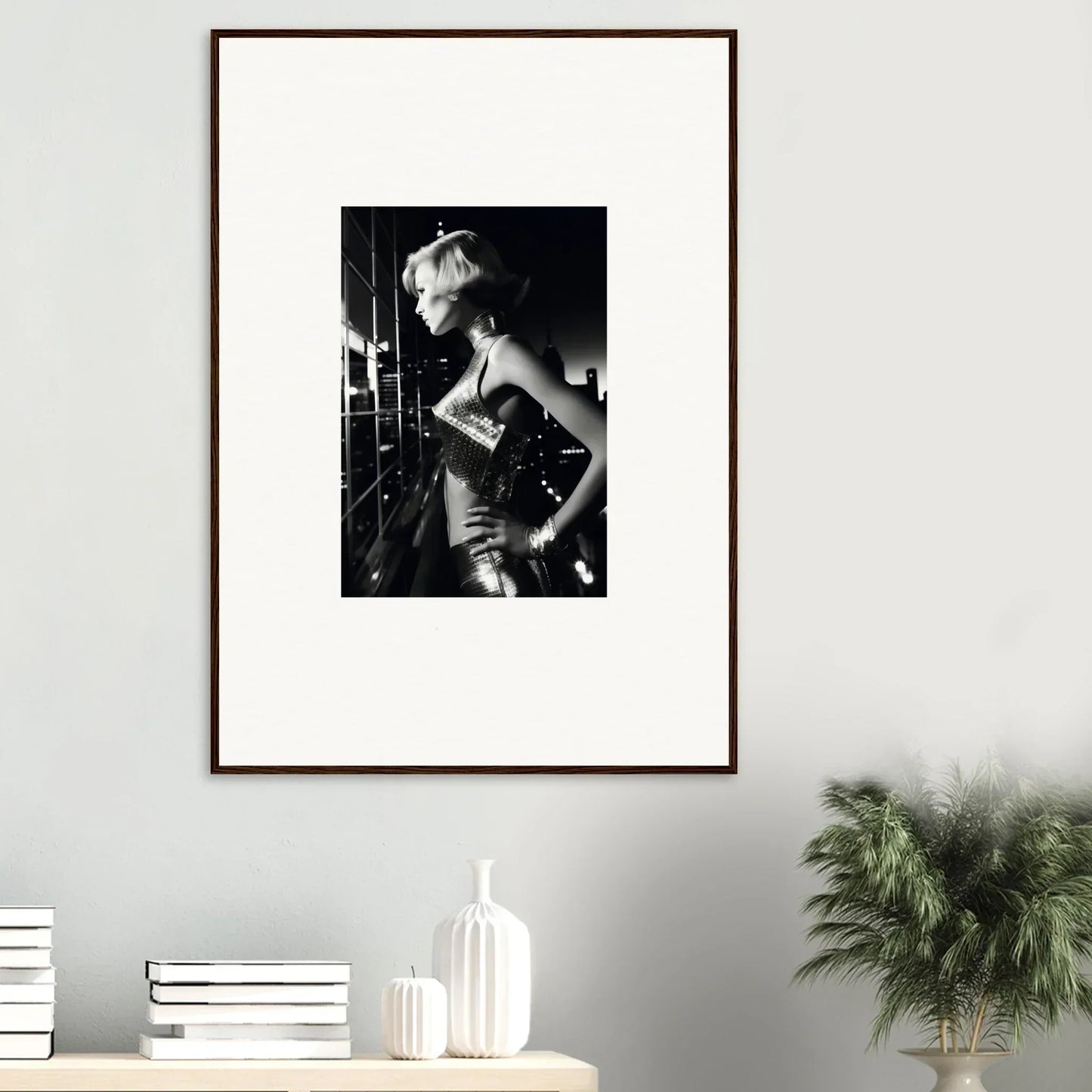 Framed black and white photograph of a woman in a glamorous pose.