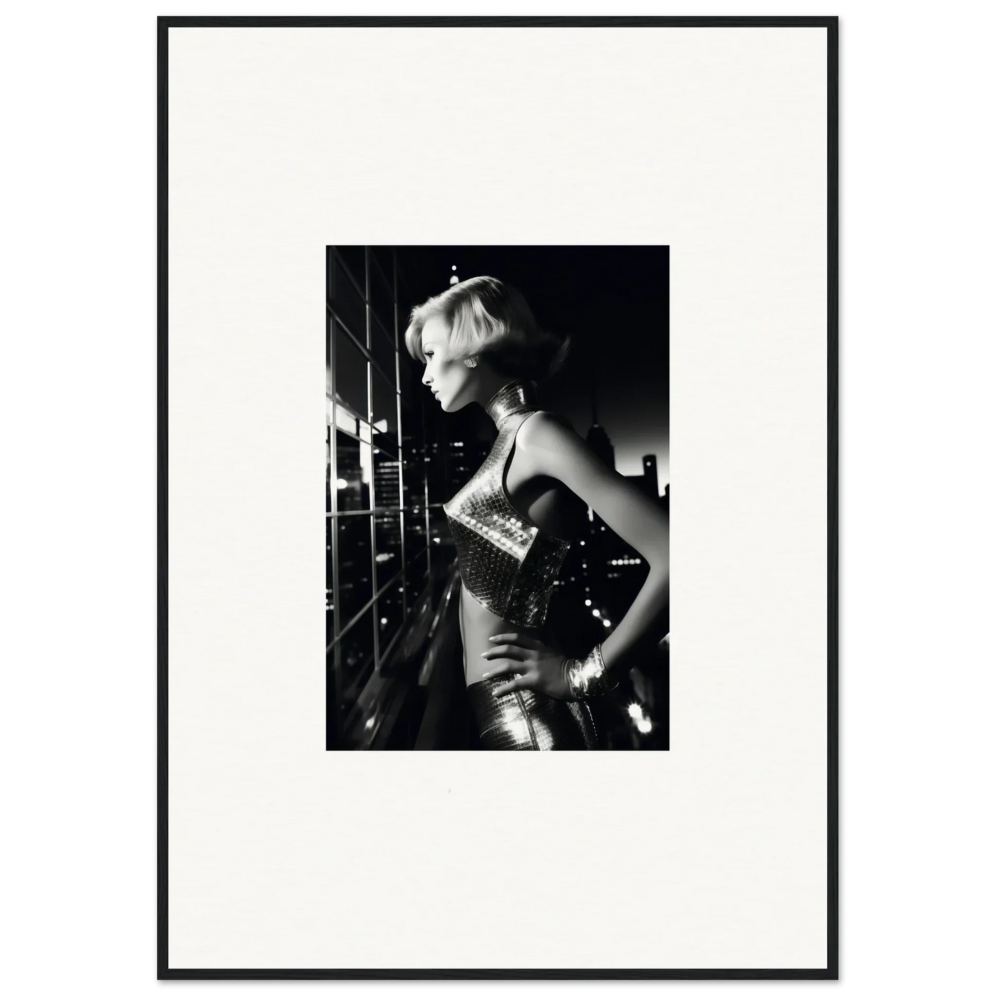 Black and white photograph of a woman in a shimmering outfit with short blonde hair.