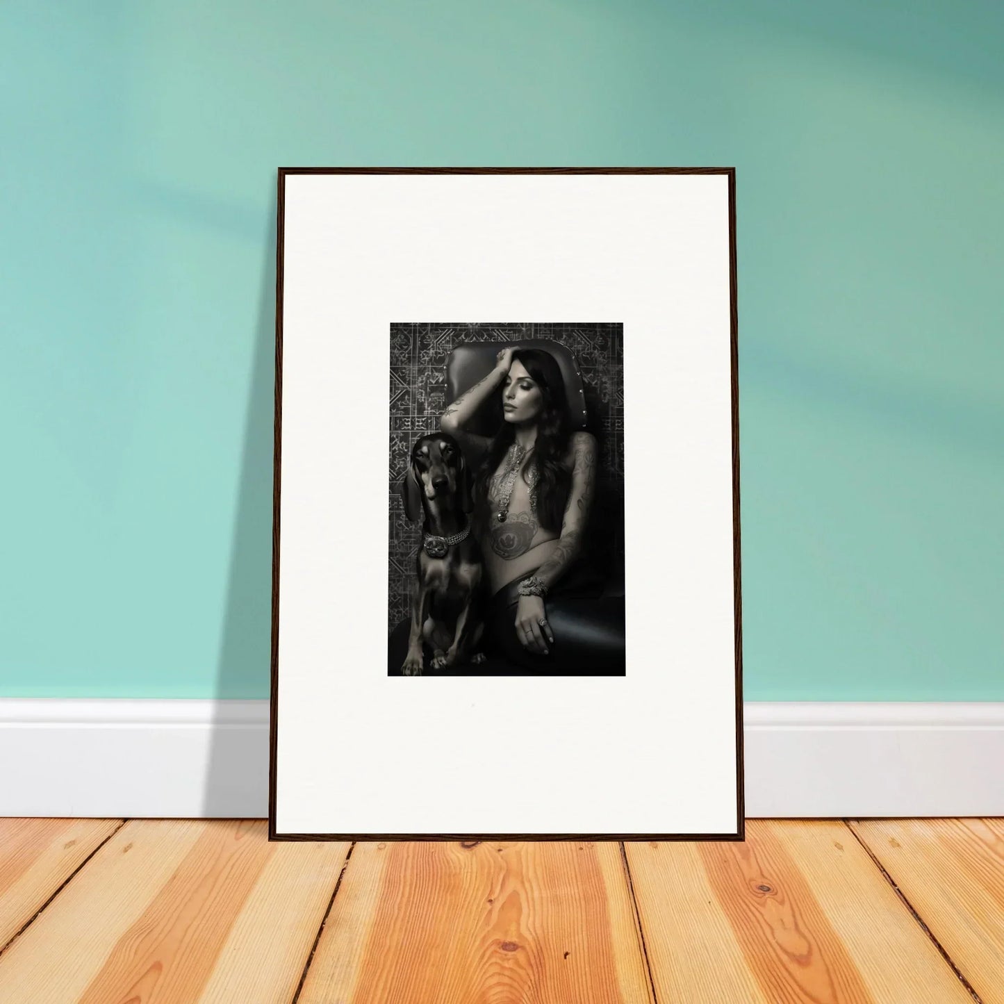 Framed black and white photograph of a person with a dog.