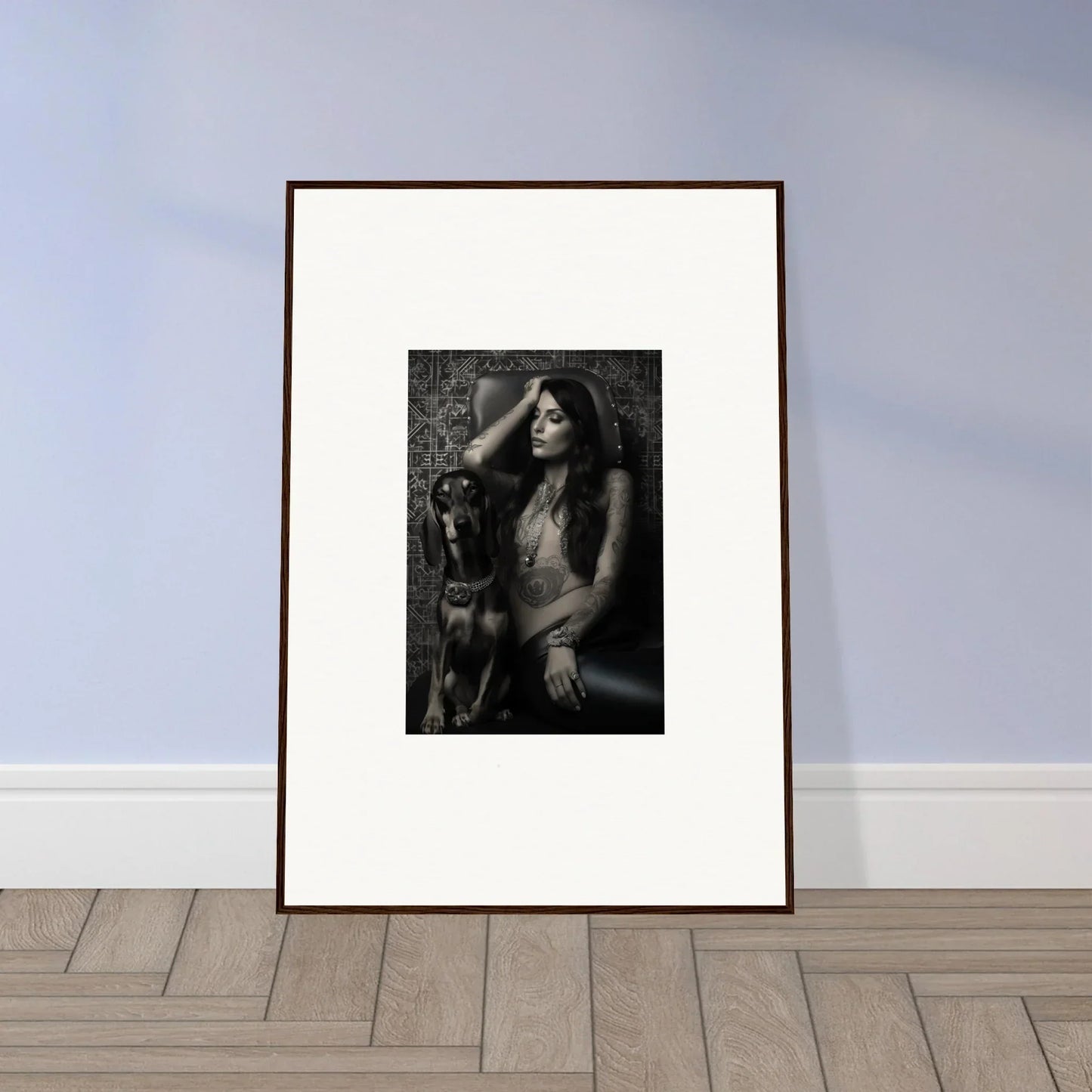 Framed black and white photograph of a woman posing with a dog.