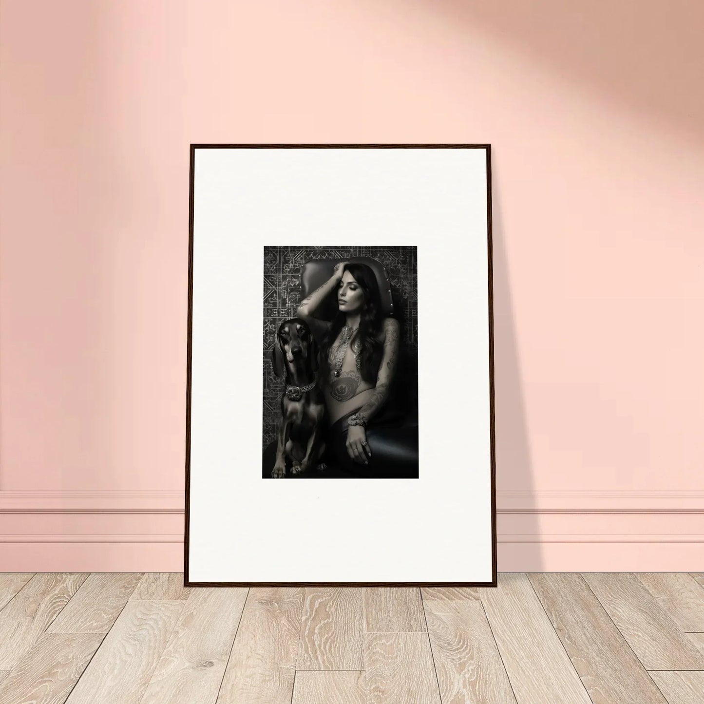 Framed black and white photograph of a woman posing with a dog.