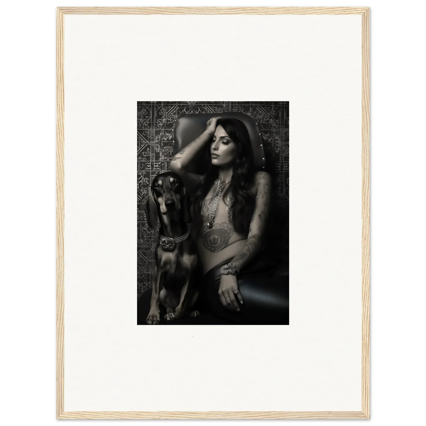 Black and white photograph of a woman posing with a dog, framed in a light wooden frame.