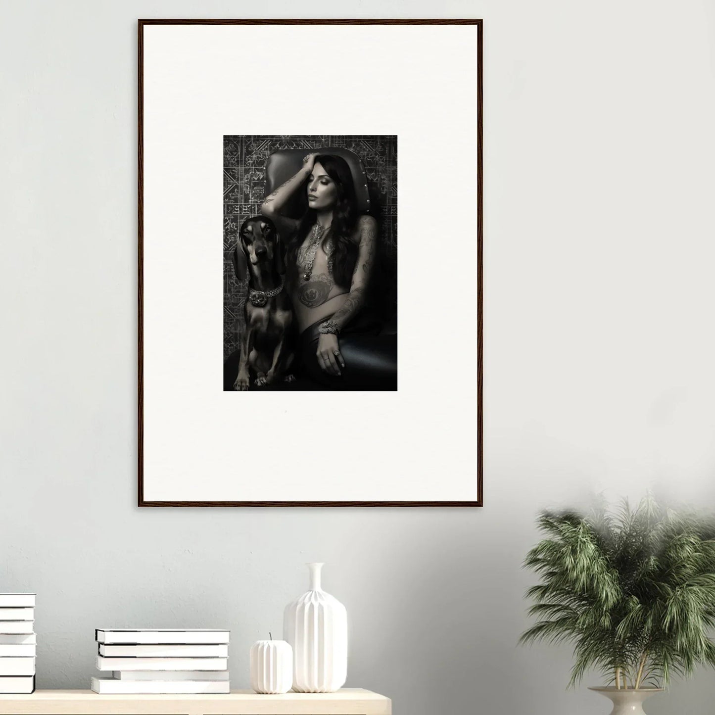 Framed black and white photograph of a person with long hair in an expressive pose.