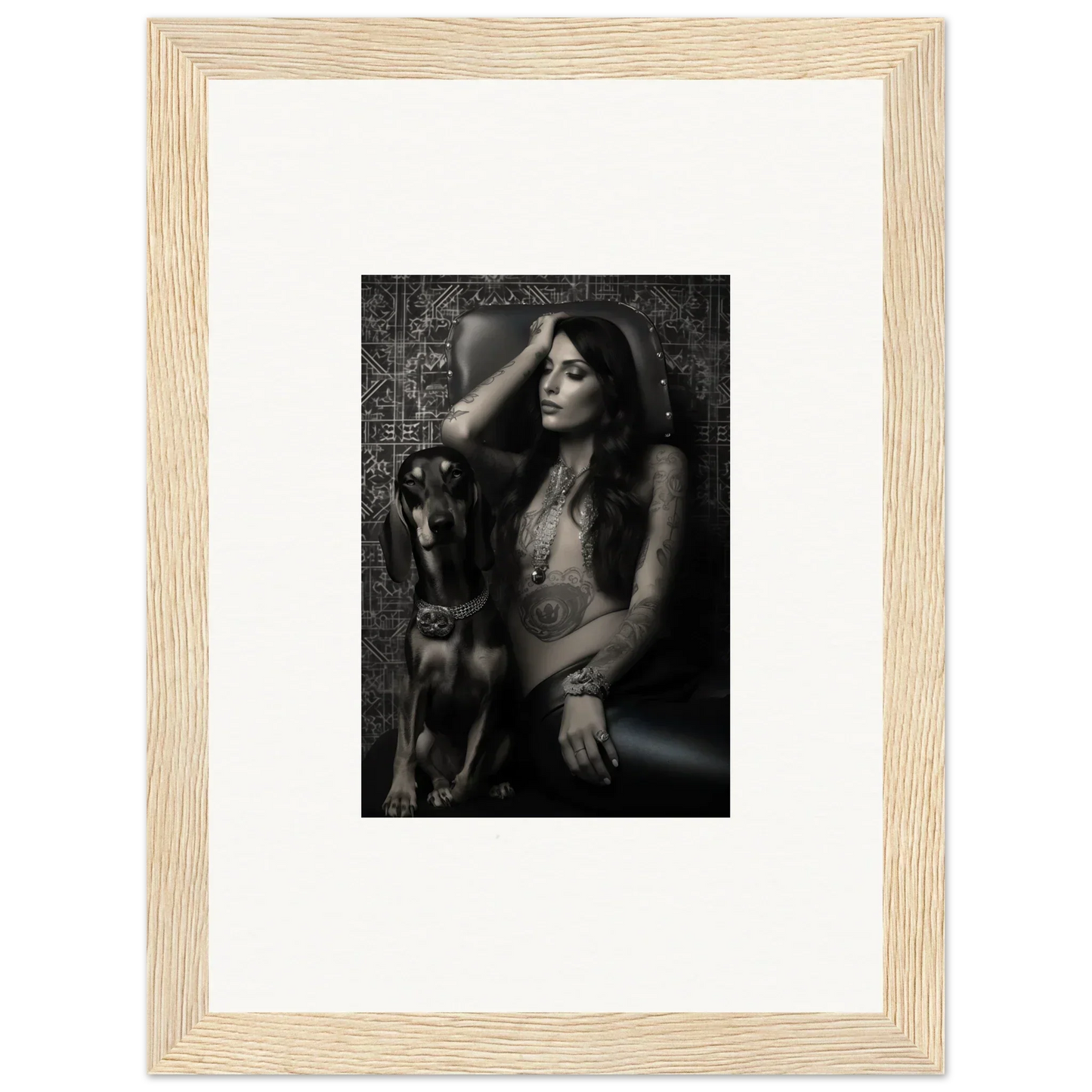 Black and white photograph of a woman posing with a dog, framed in a light wooden frame with a white mat.