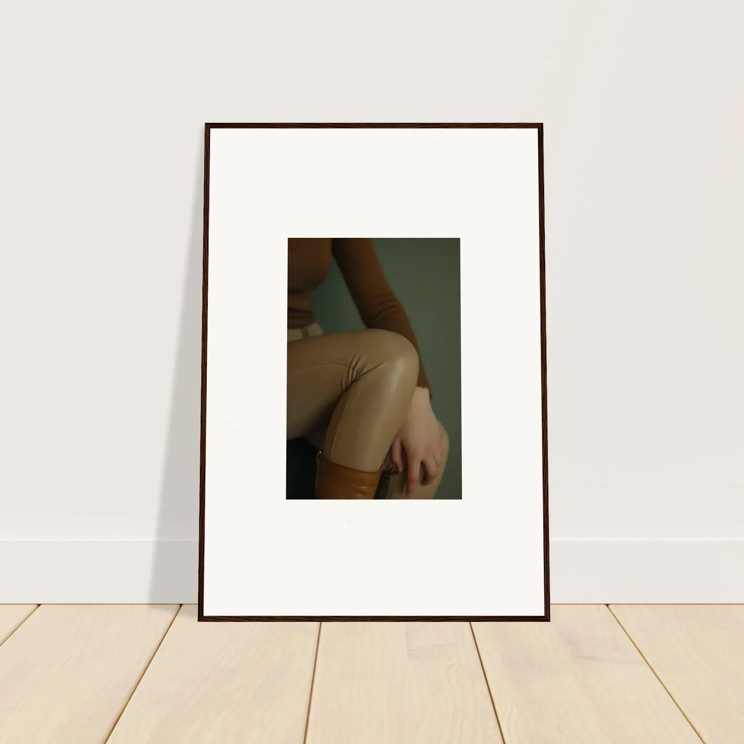 Framed photograph showing a close-up view of a person’s bare shoulder and upper arm.