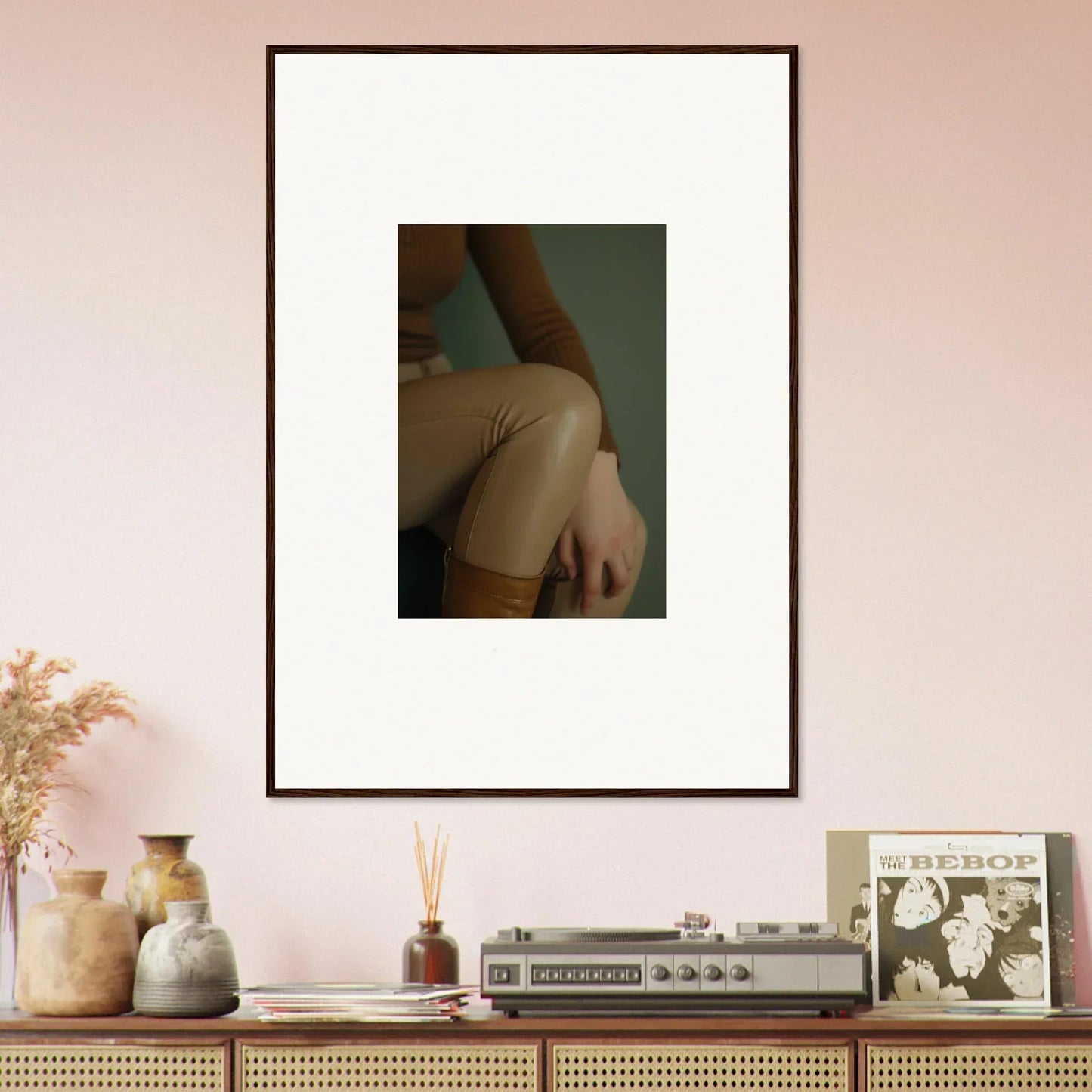 Framed photograph of a person’s arm and torso against a plain background.