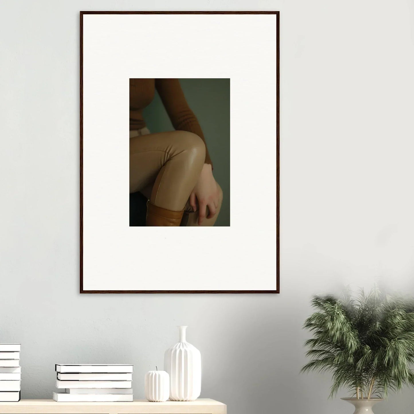 Framed photograph showing a close-up view of a person’s bare shoulder and arm.