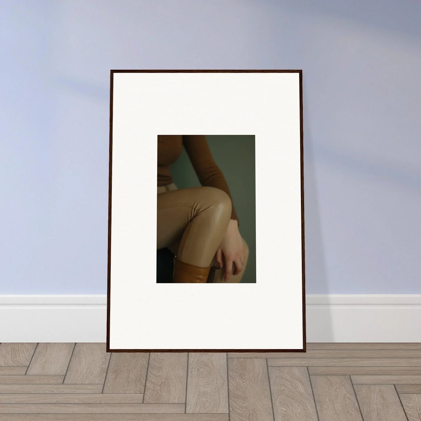 Framed photograph showing a close-up of a person’s bare shoulder and arm.