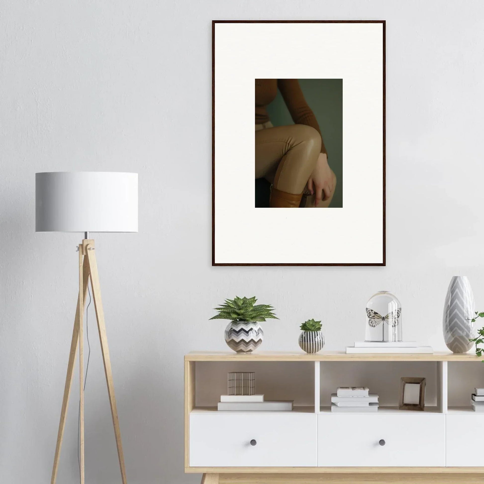 Framed artistic photograph of a person’s shoulder and arm against a muted background.
