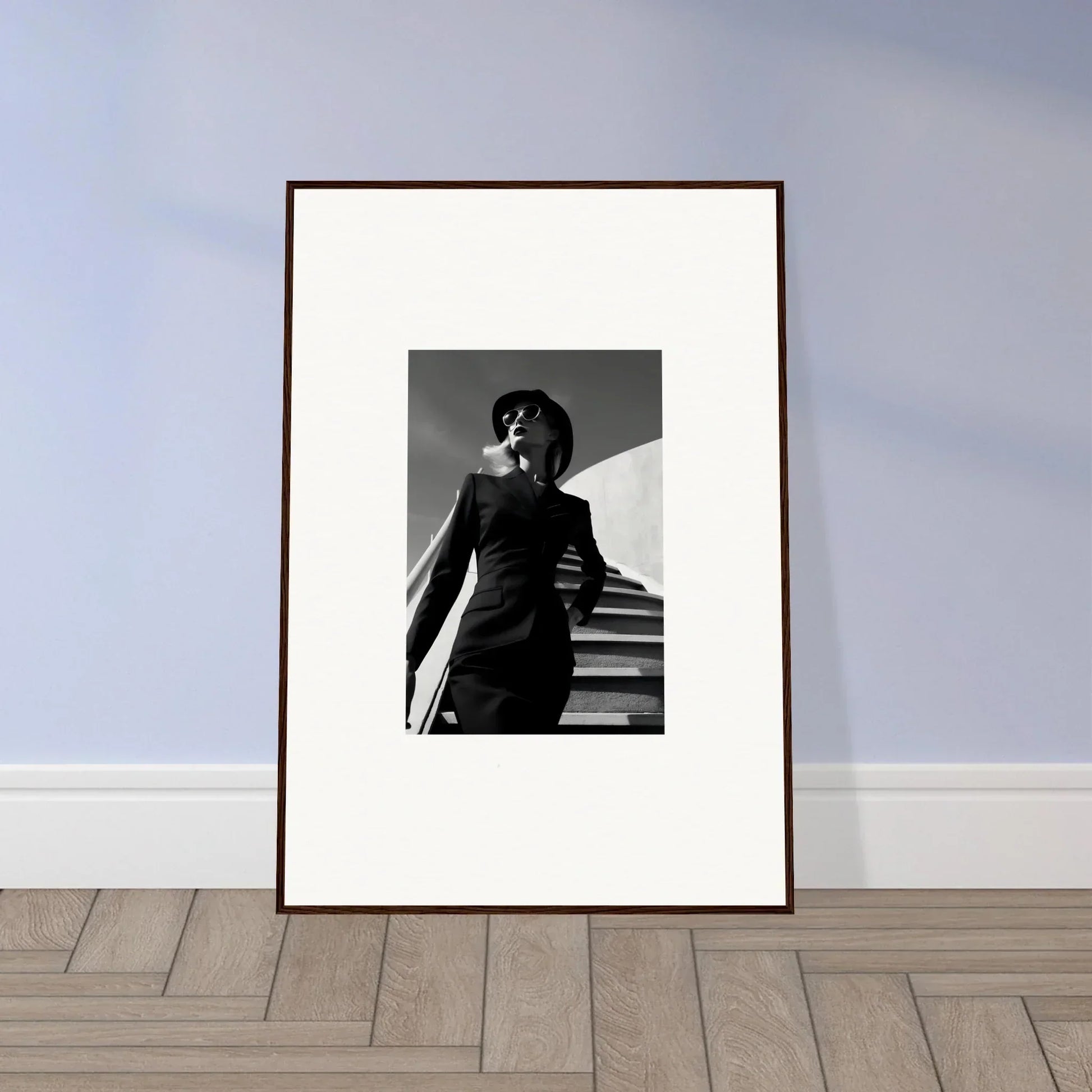 Framed black and white photograph of a person in sunglasses standing on stairs.