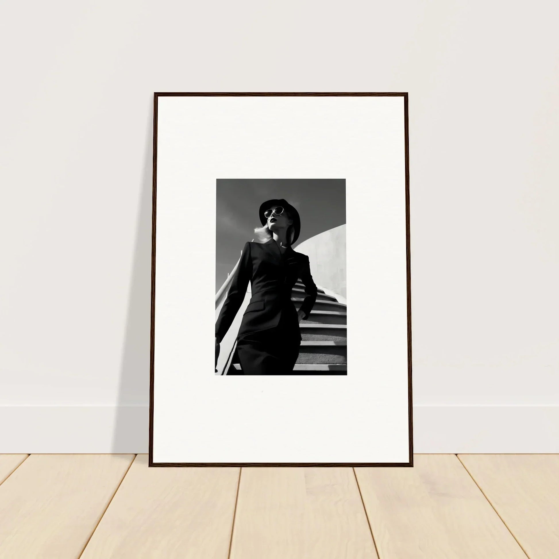 Framed black and white photograph of a person standing on stairs.
