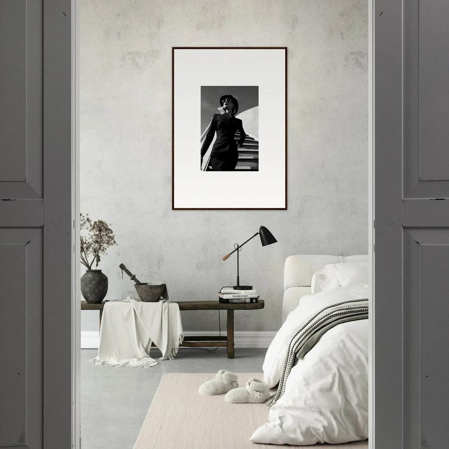 Framed black and white photograph of a person on stairs hanging on a wall.