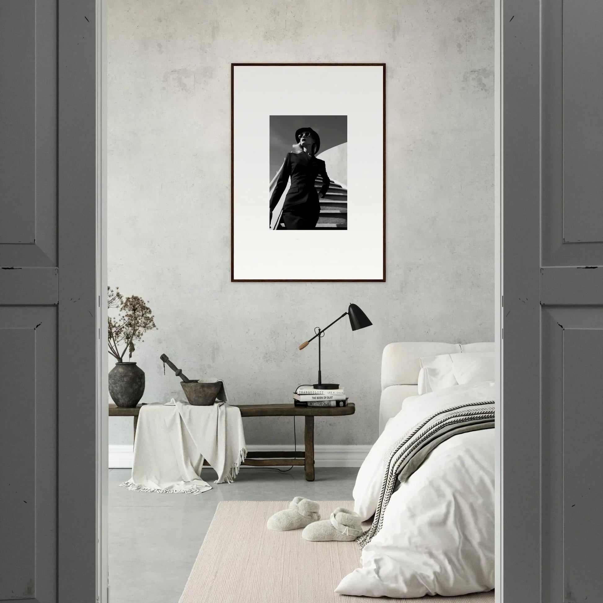 Framed black and white photograph of a person on stairs hanging on a wall.