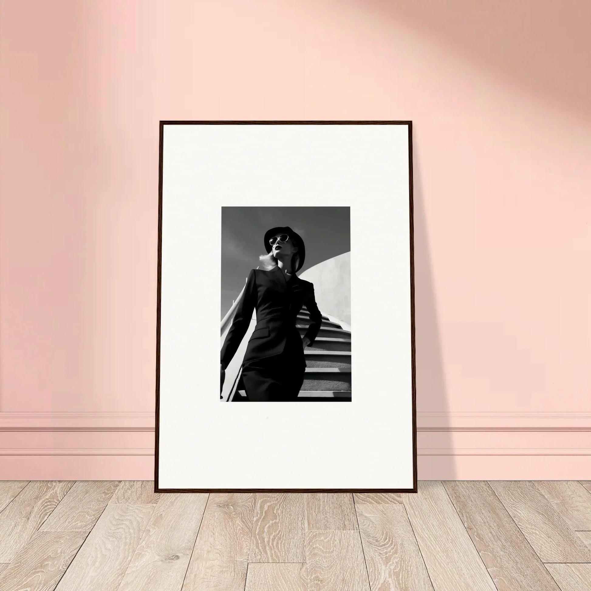 Framed black and white photograph of a person on stairs with dramatic lighting.