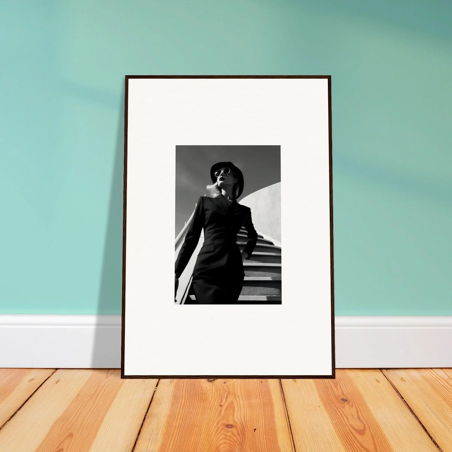 Framed black and white photograph of a person on stairs.