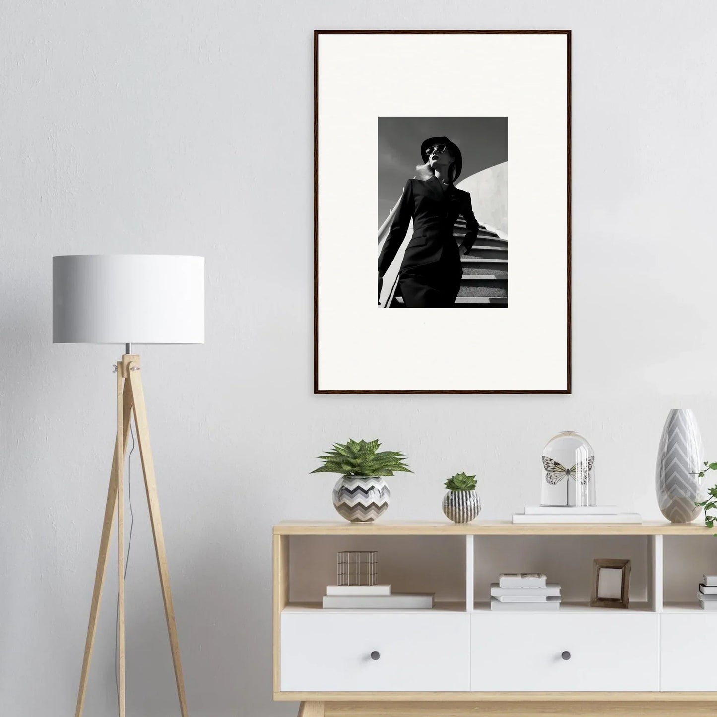 Framed black and white photograph of a person standing on stairs.