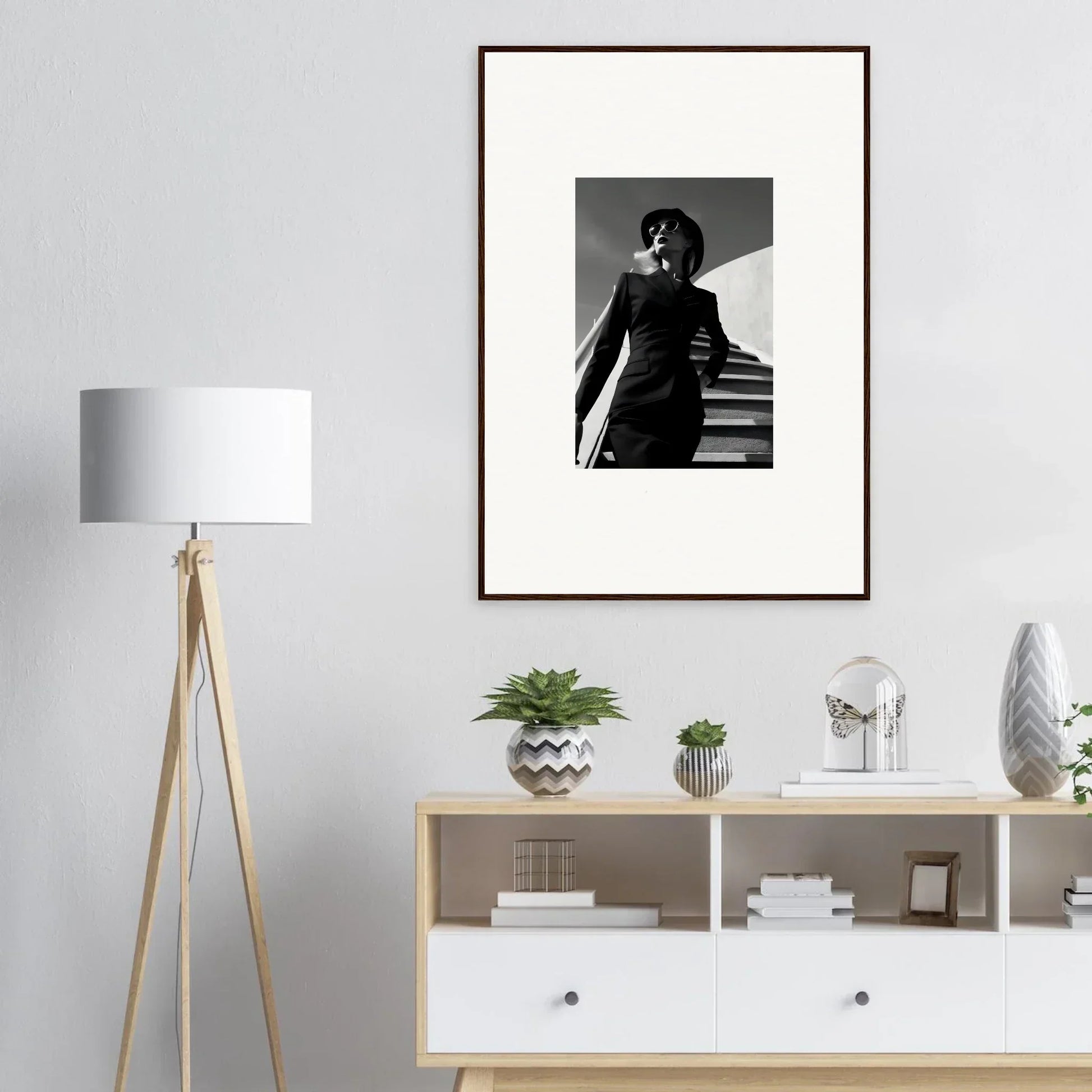 Framed black and white photograph of a person standing on stairs.