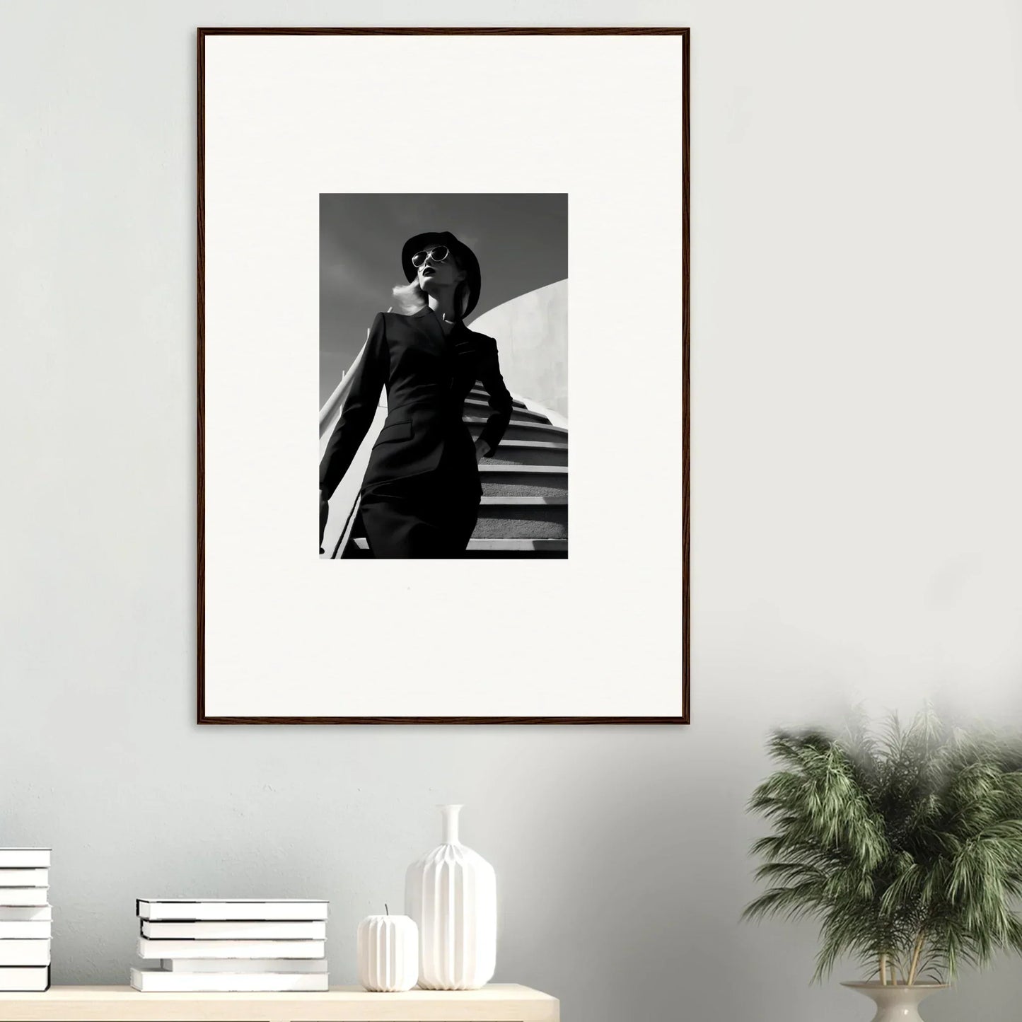 Framed black and white photograph of a person on stairs in a dramatic pose.