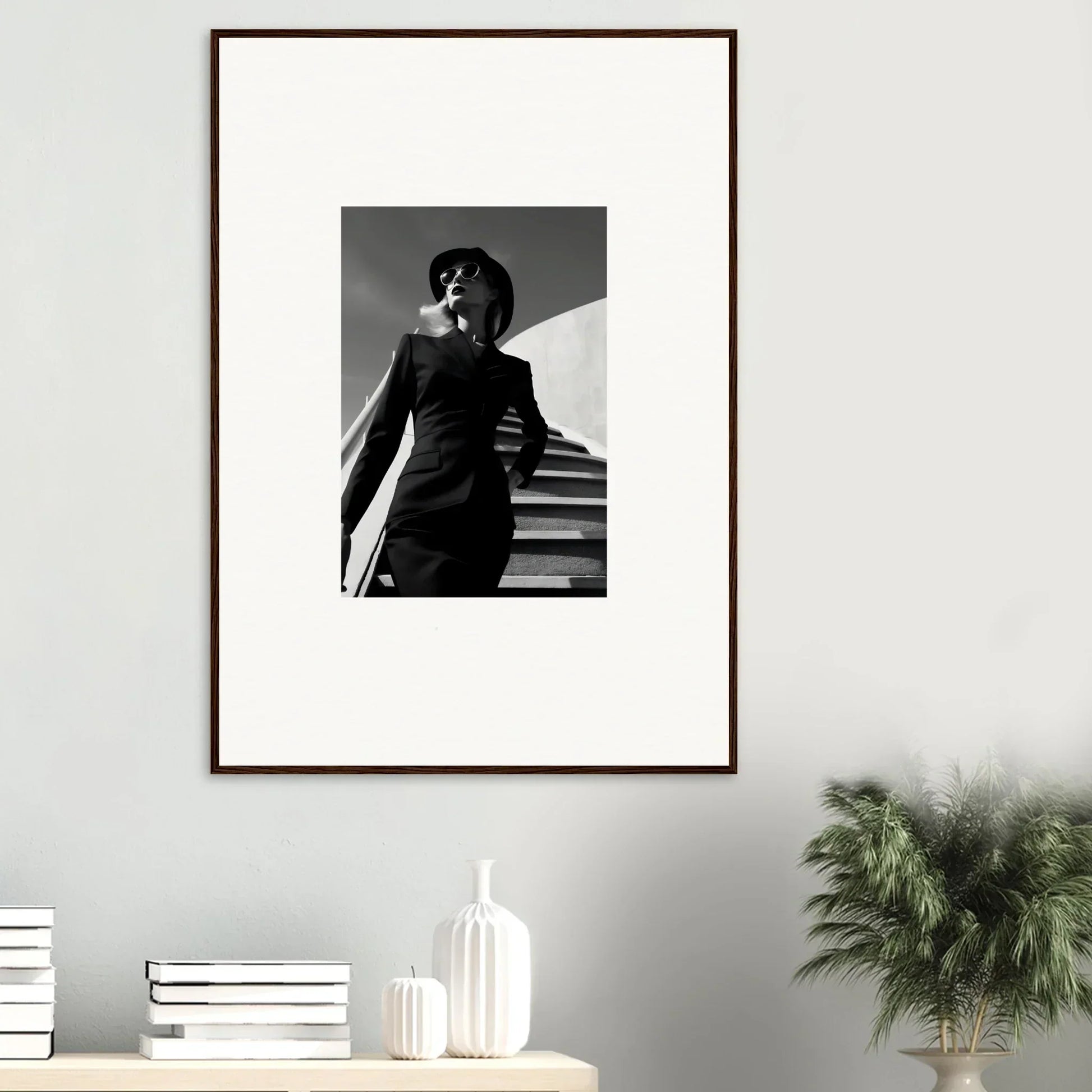 Framed black and white photograph of a person on stairs in a dramatic pose.